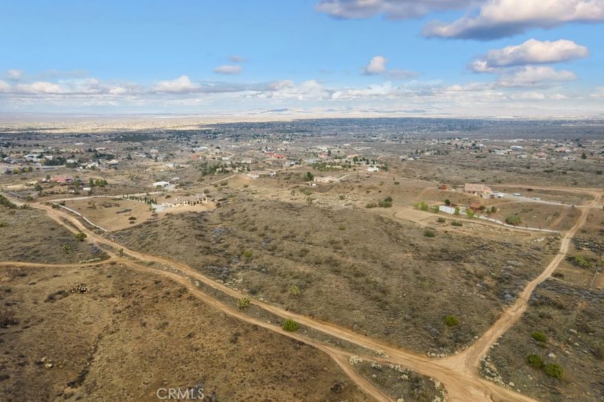 This expansive 8.79 acre lot offers sweeping views of the majestic mountains and tranquil desert landscape. With flat, usable terrain and PH/RL zoning, this property presents endless potential for future development or your dream retreat. The property is close to town and is in the Snowline School district.