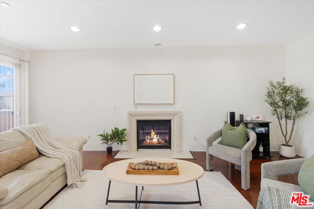 Very spacious 3-bed, 2-bath condo in north part of Koreatown! Built in 2009, this 1,450 sq ft home features an open layout with engineered hardwood floors, central HVAC, and a cozy fireplace. Only 3 units per floor. On the market for the first time in 16 years, the seller has maintained this residence impeccably you won't find a scratch on the floors or stains in the bathrooms. The kitchen has stainless steel appliances, Caesarstone counters, glass-tile accents, and generous cabinetry. Bedrooms are generously sized, including a large primary suite with a walk-in closet and oversized bathrooms. Enjoy two outdoor spaces a private balcony with neighborhood views plus a Juliet balcony. Additional highlights include an in-unit washer/dryer, intercom system, two parking spaces in a secure garage, guest parking, and low HOA dues. The HOA covers: building insurance, CCTV, grounds maintenance, janitorial services, trash, plumbing, gas, and LADWP (fire, water, sewer, electric) offering excellent value and peace of mind. Situated in a charming Spanish-style building with controlled access and elevator service. This home places you in the heart of Koreatown, just steps from its vibrant restaurants, shopping, and public transit, and only a 6-minute drive to Larchmont Village, 10 minutes to the trendy neighborhoods of Silver Lake, close to Los Angeles City College (LACC), and conveniently near the 101 Freeway. Enjoy easy access to local favorites like Sqirl Cafe and Courage Bagels while taking full advantage of this unbeatable location. EV charging is allowed at owners expense and with HOA approval.