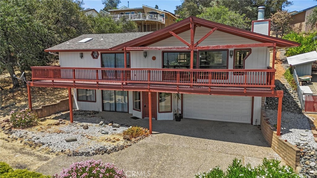 Welcome to your dream retreat! Located in Kelly Ridge, this stunning 2-bedroom, 2.5-bathroom home offers sweeping panoramic views of Lake Oroville and the surrounding foothills—a rare opportunity to own a home where nature meets comfort in perfect harmony. With over 2,060 square feet of thoughtfully designed living space, this home impresses from the moment you step inside. The open-concept floor plan features vaulted, beamed ceilings, recessed lighting, and a wall of sliding glass doors that flood the home with natural light and frame picture-perfect views from the covered deck—an ideal space for morning coffee, sunset dinners, or weekend entertaining. Love to cook? You’ll feel right at home in the spacious kitchen, complete with range, oven, microwave, dishwasher, double-basin sink, and a welcoming breakfast bar—perfect for gathering with friends and family. The primary suite is your private haven with its own slider to the deck, walk-in closet, and spa-style bathroom with a walk-in shower. An additional bonus room offers flexible space for a home office, hobby room, or guest quarters. You’ll also appreciate the full laundry room, ceiling fans, central heat & air, and an attached 2-car garage. All of this is set on a peaceful 0.19-acre lot in a desirable hillside location just minutes from shopping, dining, hiking, boating, and the best outdoor recreation Oroville has to offer. This is more than just a home—it’s a lifestyle. Whether you're looking for a serene full-time residence or a weekend escape with unforgettable views, this is the one you've been waiting for. Don’t miss your chance—homes with views like this don’t stay on the market for long!