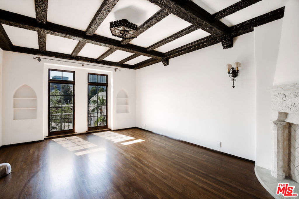 After nearly a century standing proudly in the heart of West Hollywood, the breathtaking El Mirador Apartments reopens its doors. Reborn, refined, and ready to welcome a new generation of residents. Following more than a decade of meticulous and sensitive restoration, this architectural jewel is a prime example of Churrigueresque Spanish Colonial Revival design and has been returned to its original splendor. Built in 1929 by renowned theater architect S. Charles Lee, it stands as a remarkable tribute to its era. Original floorboards were carefully lifted, revarnished, and placed back with reverence. Decades of paint and primer were patiently removed from hand-carved archways to reveal the craftsmanship beneath. Custom-imported rugs now line the grand corridors. Every salvageable element of the building's storied past has been preserved, fought for in some cases, with an unrelenting commitment to authenticity. In El Mirador, the devil is not just in the details. It is in the devotion. Inside each residence, modern comforts blend seamlessly with historic charm. Kitchens feature state-of-the-art appliances set in sleek marble surrounds. Discreet cabinetry conceals in-unit washers and dryers, while retractable screens disappear into window casings to preserve uninterrupted views. Modern comforts seamlessly blend with historic charm.