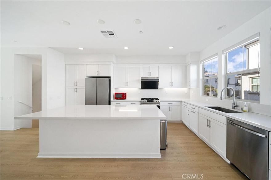 This stunning tri-level townhome, located in Claremont’s highly sought-after Docente community, was built in 2024 and offers sun-filled, stylishly upgraded, move-in ready living. With 3 spacious bedrooms and 3.5 luxurious bathrooms, the home perfectly blends modern elegance with smart functionality. The open-concept living and dining area is bathed in natural light, showcasing sleek quartz countertops, designer cabinetry, warm wood flooring, and premium Samsung appliances, all opening to a breezy private balcony. Designed for today’s lifestyle, the layout features two upstairs primary suites with walk-in closets and spa-like en suite baths, plus a private first-floor guest suite—ideal for visitors or multi-generational living. Enjoy one of the largest gated patios in the community, perfect for relaxing or entertaining, along with a built-in tech center for remote work or study. Additional upgrades include solar panels, smart home features, energy-efficient systems, and an upgraded garage with epoxy flooring and custom cabinetry. Located in a vibrant neighborhood with top-rated Claremont schools, this home offers the ultimate in comfort, style, and convenience. Don’t wait—this rare opportunity won’t last long! Schedule your private tour today!