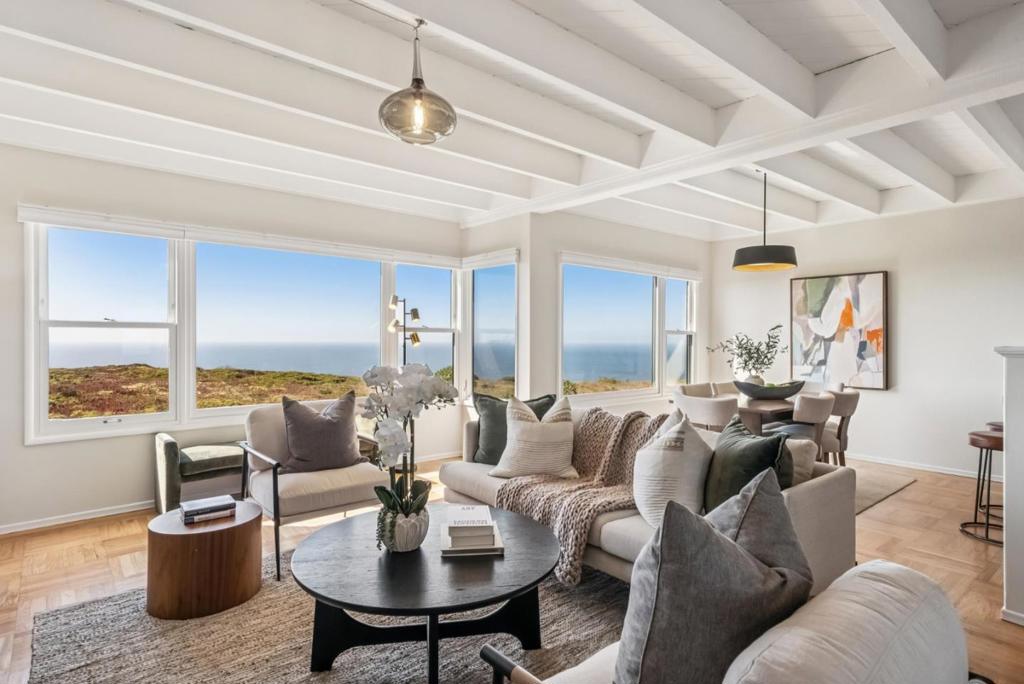 Breathtaking unobstructed ocean, cityscape, Sutro Tower, GG Bridge & Farallon Islands views in this classic mid-century Doelger single-family home. Located in the desirable Westlake Palisades neighborhood and renovated for modern living. An open floor plan features a wall of Marvin dual-paned windows overlooking the ocean and green belt. Fresh paint, refinished solid oak hardwood floors, wood beam ceilings, stylish light fixtures, a remote gas fireplace, & a chef's kitchen with expansive quartz countertops, bar seating, stainless-steel appliances, and modern cabinetry. Four bedrooms include the primary suite, two additional bedrooms, and two remodeled bathrooms upstairs. Custom closet organizers enhance storage. The lower level offers a fourth bedroom with rear yard access, which could also serve as a fantastic family room or home office. Low-maintenance backyard plus a wonderful play and dog park nearby. Significant expansion potential exists in the large two-car garage with exceptional storage. (washer, dryer, and refrigerator remain) Convenient access to San Francisco, Trader Joe's, Westlake, Stonestown, BART, the ocean, the zoo, major freeways, and schools. A perfect mid-century gem, ideal for entertaining or relaxing while enjoying stunning panoramic views from dawn to dusk!