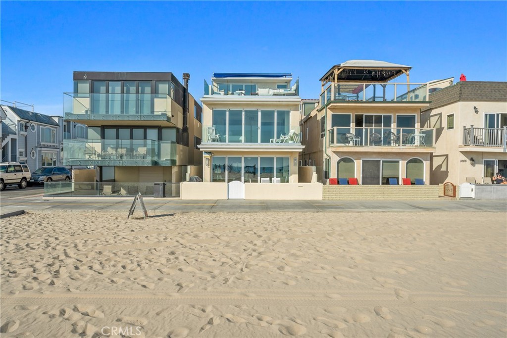 Discover a rare opportunity to own a modern beachfront home in one of Newport Beach’s most coveted locations. Ideally positioned on the boardwalk at 34th Street, this three-story residence—with a transferable short-term lodging permit—offers sweeping ocean and Catalina Island views, high-end design, and effortless coastal living just steps from the sand.
Designed to maximize natural light and capture panoramic vistas, the home features floor-to-ceiling infinity glass doors on all three levels, seamlessly blending indoor and outdoor spaces. The main level showcases an open-concept layout anchored by a chef’s kitchen with stainless steel appliances, Sub-Zero refrigerator, custom cabinetry, and elegant countertops—perfect for both everyday living and entertaining.
Upstairs, three spacious bedrooms each offer ensuite baths and walk-in closets. The luxurious primary suite opens to a private ocean-facing deck and includes a spa-style bath with soaking tub, steam shower, separate water closet, and expansive closet space. A third-floor bonus room with a full bath opens to the rooftop deck, where a boardwalk-facing hot tub, lounge seating, and retractable awning create the perfect space to unwind or entertain.
Additional amenities include a full-size laundry room with generous storage, smart TVs throughout, USB-integrated outlets, a modern security system with exterior cameras, and a two-car garage with EV charging outlets.
Currently operated as one of Newport Beach’s highest-performing short-term vacation rentals, this property delivers strong, consistent income. It has been professionally managed for over a decade, and the current owner has maintained it in pristine condition. Its prime oceanfront location, turnkey condition, and rare transferable permit make it a standout investment for buyers seeking a hybrid of lifestyle and income potential.
Whether you're looking for a full-time residence, second home, or income-producing coastal retreat, this exceptional property offers immediate value—and a rare chance to own a proven performer in one of Southern California’s most iconic beachfront communities. (Verified income records available upon request; short-term lodging permit transfers to the buyer.)