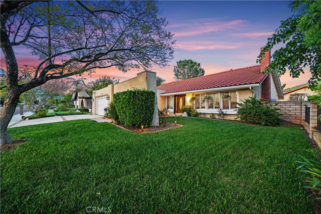 Fountainwood single story with beautiful Jacaranda shade tree and courtyard entry, excellent for added privacy and relaxation with abundant grass lawn. Hardwood and granite floors. Open concept sunny kitchen with quartz countertops and stainless appliances open to the large family room with high vaulted beam ceiling, both overlooking the lovely backyard with patio outdoor dining and living, swimmers pool, fruit trees roses and more. Large formal living with fireplace, high vaulted ceilings and formal dining. Renovated bathrooms. Large primary suite with double closets and new double vanity. Plantation shutters, vinyl dual pane windows. Pool and spa re-plastered in 2021. New HVAC in 2020. Award winning Las Virgenes Schools. Sumac Elementary. AE Wright, Agoura High School. A must see!