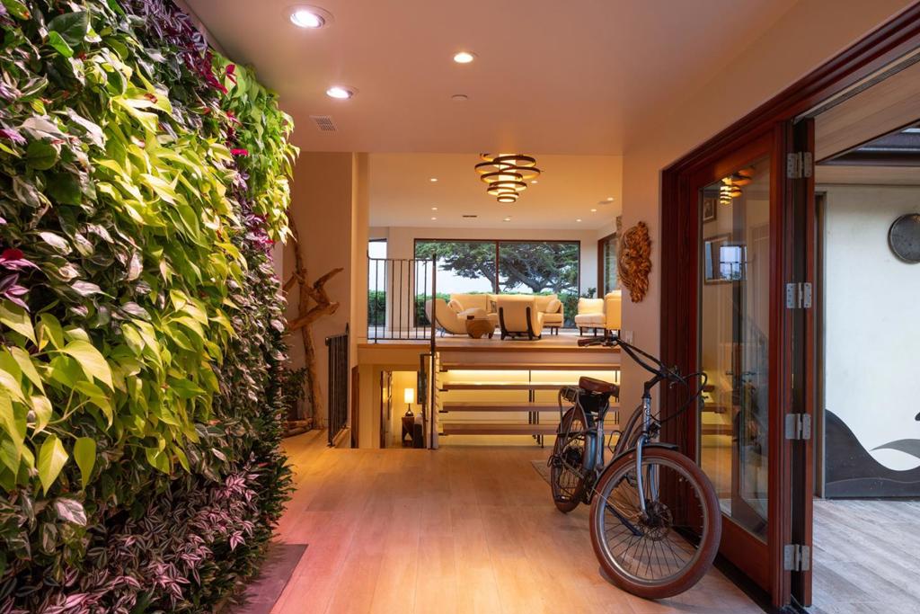 Located on coveted Carmel Point, just one block from both of Carmel's world-famous beaches, this beautifully remodeled Green Point Rated home has gorgeous views stretching from Carmel Bay to Pebble Beach and is a Net Zero Energy home with carbon-neutral and sustainable features. The objective of the comprehensive remodel was to create a biophilic (nature-centric) home while reducing its ecological footprint by incorporating energy and water-efficient features, using only ecologically-friendly materials in ways that are both attractive and inspiring. Materials on the Red List were not used. Huge windows bring the outdoors inside with the living room area boasting fabulous sand and whitewater views. Other highlights include 3 bedrooms, 3 bathrooms, a custom metal and glass front door, indoor living wall designed with plants in different textures, shapes and colors to highlight the spiral pattern complementing the wave motif on the front door, a well-appointed kitchen, natural wine cellar, and custom metalwork throughout. With outstanding options for dining, shopping, and outdoor activities within close proximity, this harmoniously designed Carmel beach house is ready for its lucky new owners to enjoy for years to come.