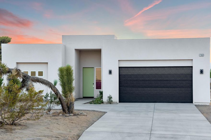 Reintroduced to the market with a significant price improvement!  Welcome to 7082 Avalon Avenue -- a brand new sanctuary in the heart of Yucca Valley. Thoughtfully designed and freshly completed, this 3-bedroom, 2-bathroom home offers 1,560 square feet of modern living on nearly half an acre, blending style, efficiency (paid solar), and open-concept comfort. From the moment you arrive, the striking White Coconut exterior, accented by a bold black garage door and vibrant green entry details, makes a memorable first impression. A spacious 2-car garage provides secure parking and additional storage, while wide side yards offer plenty of room for RV parking, trailers, or additional toys -- perfect for desert adventurers. Step inside and you'll immediately be greeted by a light-filled, open floor plan that seamlessly connects the living, dining, and kitchen areas -- ideal for everyday living and effortless entertaining. The kitchen is a showstopper, featuring quartz countertops, crisp white tile backsplash, a spacious center island with bar seating, and a full suite of brand new Samsung stainless steel appliances. A large walk-in pantry and a dedicated laundry room with washer, dryer, folding counter, and built-in cabinetry add convenience and function. Tucked privately at the back of the home, the primary suite offers backyard access via sliding glass doors, a walk-in closet, and a spa-inspired bath with dual vanities and a sleek, glass-enclosed shower. Two additional bedrooms and a full guest bath are located near the front of the home, offering ideal separation and flexibility for guests, family, or a home office setup. Step outside and you'll find a blank-slate backyard ready to be transformed into your dream outdoor oasis. Enjoy stunning desert sunsets from the covered patio while taking in panoramic mountain views to the northwest and uninterrupted open skies to the east.Just minutes from essential amenities like Walmart, Home Depot, and Stater Bros, this location balances quiet desert living with everyday convenience -- all while being just a short drive to Joshua Tree National Park, Palm Springs, and beyond. Come check out this new modern home today!