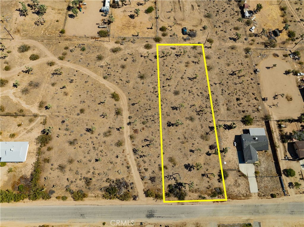 Welcome to this exceptional piece of land, offering just under 3/4 of an acre of flat buildable space adorned with iconic Joshua trees. Located along a paved road, this lot provides easy access and convenience. You'll appreciate the short drive to town for all your necessities, while still enjoying the peaceful seclusion that comes with being far enough away from the hustle and bustle. Utilities are available in the street, making the development process smooth and efficient. With stunning views and a prime location, this property is a rare find. Don’t miss the opportunity to own a piece of the picturesque Yucca Valley area. The address is fictitious to help locate with GPS. Parcel # 0598-103-33-0000
