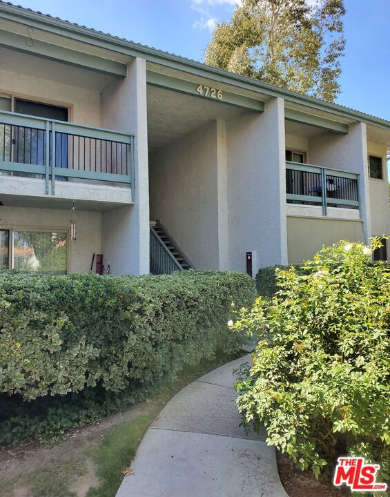 This beautifully maintained upstairs unit offers 1,006 sq. ft. of comfortable living space in the highly sought-after Oak Park Condominium Community, located just off Park Granada. The residence features laminate wood flooring, recessed lighting, and an updated kitchen equipped with a refrigerator, plus a convenient side-by-side washer and dryer. A sliding glass door opens to a private tiled deck, perfect for relaxing or entertaining. The primary suite is generously sized, complete with a walk-in closet and an en-suite bathroom featuring dual sinks, a large tub with shower. The unit also includes two assigned side by side carport spaces with overhead storage, situated near the residence for added convenience. Community amenities include a resort-style pool and spa, fitness room and exclusive access to scenic Calabasas Lake. Residents will also enjoy being steps away from The Commons at Calabasas, offering premier shopping, dining, and entertainment options.Located within the award-winning Las Virgenes School District. Available for immediate occupancy.