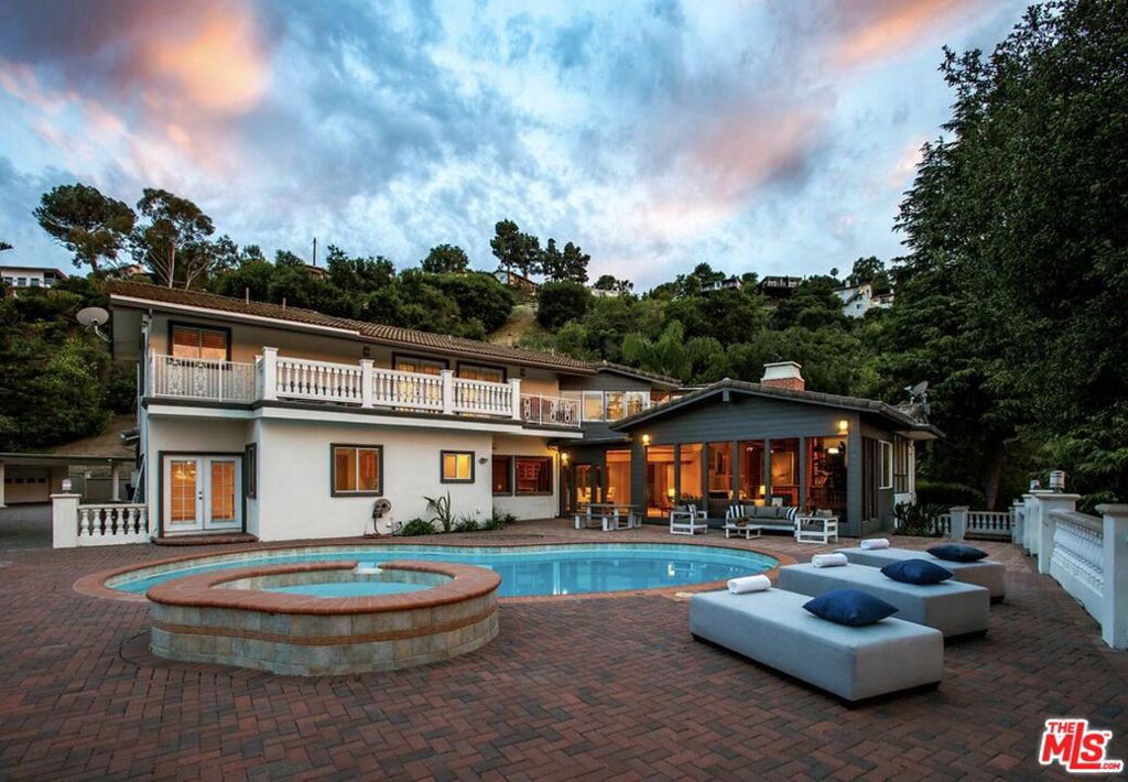 Nestled on a serene and private 1.6-acre gated compound in the prestigious Hollywood Hills, this exceptional estate offers sweeping views of Universal Studios, the Santa Monica Mountains, and the San Fernando Valley. As you arrive through the gated entrance, a picturesque, winding driveway leads to a generous motor court accommodating up to ten vehicles. The residence features a spacious and inviting traditional design, complemented by expansive indoor and outdoor living areas. The backyard is a true entertainer's paradise, with a sparkling pool and spa set against breathtaking vistas, perfect for relaxing afternoons or elegant gatherings under the stars. Offered both furnished and unfurnished and available for immediate move-in, this home provides unmatched flexibility for a variety of lifestyles. Ideally located near the finest restaurants, entertainment venues, shopping, and nightlife of Hollywood and Studio City, this is a rare opportunity to lease one of the largest and most secluded estates in the area.