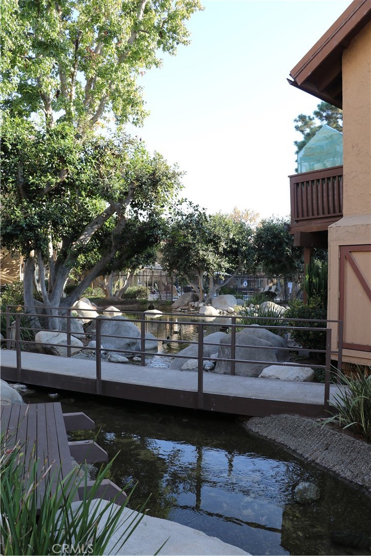 This one bedroom one bathroom unit is in turnkey condition with a back patio positioned on a stream. The kitchen includes newly installed countertops, a refrigerator, microwave, range and a brand new washer/dryer set. The unit is newly painted and has wood & tile flooring throughout. This condo also has access to tennis courts, pools, basketball courts & a clubhouse. There is one carport included directly in front of the unit.