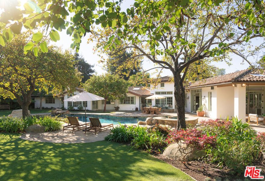 A portrait of refined California living, this renovated Hope Ranch estate blends thoughtful updates with timeless beauty both inside and out. Privately situated on nearly 1.5 gated acres, the single-level +/- 6,200 sq ft residence captures the essence of Hope Ranch living: elegant, peaceful, and seamlessly connected to the outdoors. The property's lush, park-like grounds are both immersive and calming, while its generous amenities  including a refreshing pool and spa, a tennis court, and an expansive attached pool house/activity room  make this the ideal home for quiet relaxation or effortless entertaining.Inside, the residence reflects a cohesive vision of modern refinement. Recent renovations include updated flooring, new paint, and carefully selected finishes, all contributing to the home's pristine, move-in-ready aesthetic. Throughout the home, expansive windows frame verdant outdoor views and welcome abundant natural light. Outside, meandering pathways wind through rose gardens, citrus trees, towering redwoods, and tranquil water features that converge harmoniously to create a true sense of escape.The generous floor plan includes 5 bedrooms, 6 full bathrooms, and 2 half baths, along with exceptional spaces designed for comfort and versatility. The living room, dining area, family room, and stunning kitchen & breakfast nook provide abundant gathering spaces for daily living, while sunlit nooks, custom built-ins, cozy fireplaces, and picturesque windows lend a sense of delight and discovery at nearly every turn.Just beyond the main living areas and adjacent to the pool patio, the expansive attached pool house/activity room offers a beautiful extension of the home. Flooded with natural light, this flexible space is well-suited for entertaining, wellness pursuits, creative endeavors, or even as additional guest quarters. Next to the activity room, a luxurious and cozy home theater with a loft/kids' play area guarantees enjoyment of the space for all ages.On a secluded wing of the home, the primary suite is an alluring getaway featuring a fireside sitting area, dual bathroom suites and walk-in closets, a luxurious soaking tub, and a private laundry room. Nearby sits an additional guest bedroom, as well as a magnificent wood-paneled office, providing a serene and private room for work pursuits. A comfortably separate bedroom wing with 3 additional bedrooms and a dedicated study/homework space offers wonderful flexibility for family or guests. A 3-car attached garage and second laundry area add everyday convenience to the home's thoughtful layout.Positioned near the entrance to Hope Ranch yet quietly tucked away, this gracious property offers ready access to the community's signature amenities  miles of equestrian trails, the prestigious Hope Ranch Beach with private access, and the tranquility of this celebrated coastal enclave. Although you're just moments from Santa Barbara's finest dining, beaches, and amenities, the setting feels worlds away, offering the perfect escape without sacrificing convenience. Beautifully updated and rich in character, this exceptional estate combines luxurious living with an inviting sense of charm  bright, serene, and filled with moments of daily inspiration.