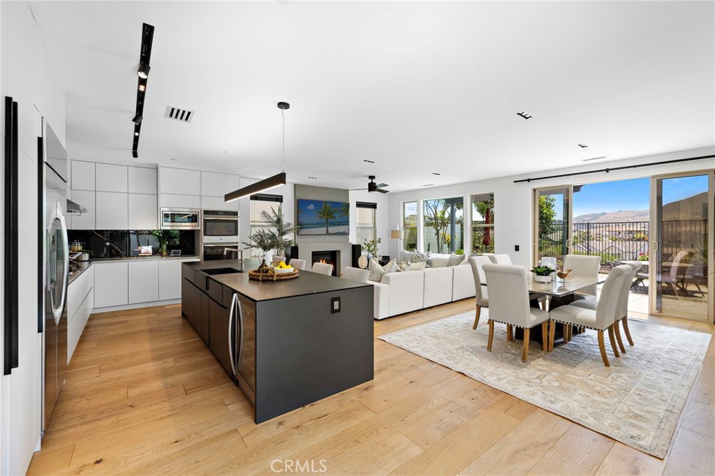 PANORAMIC VIEWS AND EUROPEAN UPGRADES! This extraordinary, one-of-a-kind designer home represents the pinnacle of luxury living, with over $600k in exclusive, high-end updates and European craftsmanship throughout. Every detail of this custom residence has been thoughtfully crafted and meticulously executed. As you step inside, you are greeted by the spacious, open floor plan enhanced with stunning White Oak hardwood floors with two layers of Portuguese cork underlayment, smooth Level 5 Drywall with Westpac joint compound, a striking 15ft+ custom stone wall in the staircase area and Decora Concrete Art Plastered fireplace. The chef-inspired kitchen is truly a showstopper, with custom European-imported cabinetry that includes German BLUM drawers and hinges, all soft-close and Rehau Resuvio anti-fingerprint surfaces. An Italian marble backsplash and ARPA innovative counters adds a touch of timeless sophistication, while top-of-the-line appliances—including a silent dishwasher and wine fridge—make this space perfect for meal prep. A Blanco sink, designer faucet, and silent-mode InSinkErator complete the kitchen, which also features a custom magnetic wall for added functionality. In the bathrooms, you’ll find custom-designed Bedrosians tiles, luxurious Hansgrohe and Kohler faucets, and premium designer sinks from Kohler and Victoria Albert. The downstairs bathroom features a hanging toilet with Geberit hardware, adding a touch of modern elegance. Every bathroom is fitted with custom hanging cabinets, steel framing, BLUM drawers, and designer countertops, creating a space that is both functional and beautiful. Signature Hardware Cohen in-tile shower drains and MAPEI Aqua Defense sealant ensure the highest standards in both design and durability. This home also comes fully equipped with state-of-the-art luxurious amenities, including Legrand Adorne designer outlets and light switches, integrated double USB-C charging outlets, Bluetooth-enabled Samsung washer and dryer, an epoxy-coated garage floor, SafeRacks garage racks and a custom European hanging cabinets adding sophistication to the garage. From the custom walk-in closet shelving to the European bamboo window blinds, every inch of this home has been designed with luxury, innovation, and attention to detail in mind. Generous lot size with multiple entertaining spaces. This is a rare opportunity to own a designer home that combines cutting-edge technology, impeccable design, and world-class craftsmanship.
