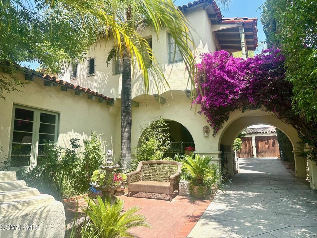 Welcome to this Romantic 1930's STUNNING SPANISH REVIVAL exuding TIMELESS CHARM and ARCHITECTURAL ELEGANCE, rumored to have been designed by distinguished Architect, Wallace Neff, located on the fantastic 1200 Block of North Everett, in the coveted and HISTORIC ROSSMOYNE neighborhood as well as pending BELLEHURST HISTORIC district of Glendale. Owner has lovingly maintained the artistic integrity of this MAGICAL PROPERTY. Nestled amidst lush greenery, and a drought tolerant front yard, this vintage gem boasts a bougainvillea lined archway and Porte-Cochere, dramatic covered entry, inviting brick front courtyard, and quaint balconies, all showcasing the ENDURING CRAFTSMANSHIP of this SPANISH STUNNER. Step inside this lovely and very livable home to discover original hardwood floors, exposed wood beamed ceilings, a Malibu tile staircase with a hand forged iron banister, custom stained glass cathedral windows, unique archways, inlaid wood doors that masterfully blends vintage Spanish details with modern comforts. All of this adding to the character and beauty of this special property. The IMPRESSIVE and EXPANSIVE step down living room is highlighted with original Mahogany wood floors, a dramatic fireplace, beamed ceiling, and French doors accessing the picturesque courtyard. The sunny eat-in kitchen and adjacent breakfast nook, both with garden views, is adorned with and painted Portofino tile accents, a vintage O'Keefe & Merritt stove/oven, and loads of cabinets. These features maintain its nostalgic vibe while accommodating today's amenities. There is also a laundry room/pantry/mud room with access to the tranquil backyard. The large formal dining room with an impressive wall of windows is perfect for entertaining. Completing the first floor, is a sizable bedroom, currently being used as a home office, that has hallway access to the full downstairs guest bathroom. The dramatic stairway leads to the upstairs landing and three spacious bedrooms with two full bathrooms. The GORGEOUS primary bedroom has multiple windows offering tree top sunset views, a walk-in closet + dressing area, and access to the romantic balcony. Both secondary bedrooms have a dedicated dressing room + closets with plenty of room for walk-in closet expansions and a charming balcony. Beautiful original tiled bathrooms enhance both the primary suite and secondary upstairs bathroom which also boasts a fun laundry chute feature and a Spanish revival Galleon Ship Port Hole window. The multi-leveled, terraced BACKYARD OASIS is a secluded sanctuary with ample room for a large pool, and is perfect for both relaxation + entertaining complete with mature trees and lush landscaping. Additional amenities include a two car detached garage with original farmhouse style wood doors, A walk down basement for extra storage needs, upgraded plumbing, sewer line, hot water recirculating system, newer water heater, dual zone AC and heating utilizing original floor vents. Conveniently located close to Glendale's best schools, parks, The Americana at Brand, Trader Joe's, Whole Foods and (coming soon) Erewhon Markets. Old Hollywood glamour meets Glendale! Make this SPECTACULAR Spanish stunner your home and OWN A PIECE OF CALIFORNIA HISTORY!!