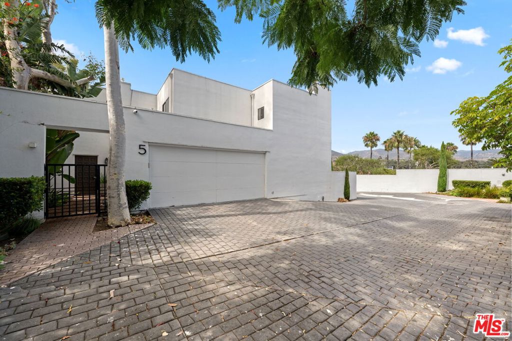 Welcome to this newly refreshed contemporary condo for lease on Point Dume. Thoughtfully updated with a clean, modern aesthetic, this residence offers a bright and inviting atmosphere enhanced by abundant natural light. Spanning two bedrooms and two bathrooms, the home combines comfort and functionality with a spacious layout ideal for both everyday living and entertaining. The main living area features beautiful hardwood floors throughout and is anchored by one of two cozy fireplaces, creating a warm and welcoming environment. French doors open to a private courtyard, seamlessly blending indoor and outdoor living while offering the perfect space for al fresco dining or quiet relaxation. The kitchen is both stylish and practical, highlighted by sleek butcher block countertops, ample cabinetry, and updated appliances. An adjacent dining area connects effortlessly to the living spaces, making it easy to host gatherings or enjoy casual family meals. In addition to the bedrooms, a versatile bonus office space provides an ideal setting for remote work, creative projects, or a quiet reading nook. Additional features include a two-car garage with direct access, a pool for residents, and in unit washer and dryer set up. Located in the heart of Point Dume, this condo places you minutes away from Malibu's iconic beaches, shopping, dining, and school campuses.