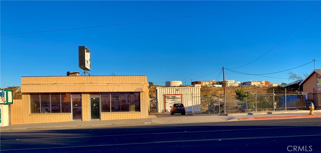 We are proud to present this terrific Commercial Property boasting a high visibility location on busy Seventh Street in Victorville with two buildings, ample parking and dual access from Seventh St. or Center St. The main building offers ~3,000 sq ft of space with an 11'x9' roll away door and a 12'x8' roll up door with two bathrooms and 10' ceilings. The second building has 14' ceilings with a 10'x10.5' roll away door and provides an additional ~1,050 sq ft. This property provides a myriad of uses and would suit a number of different owner occupied businesses or may even be used as a multi tenant investment property. Please check with the City of Victorville to confirm allowable uses.