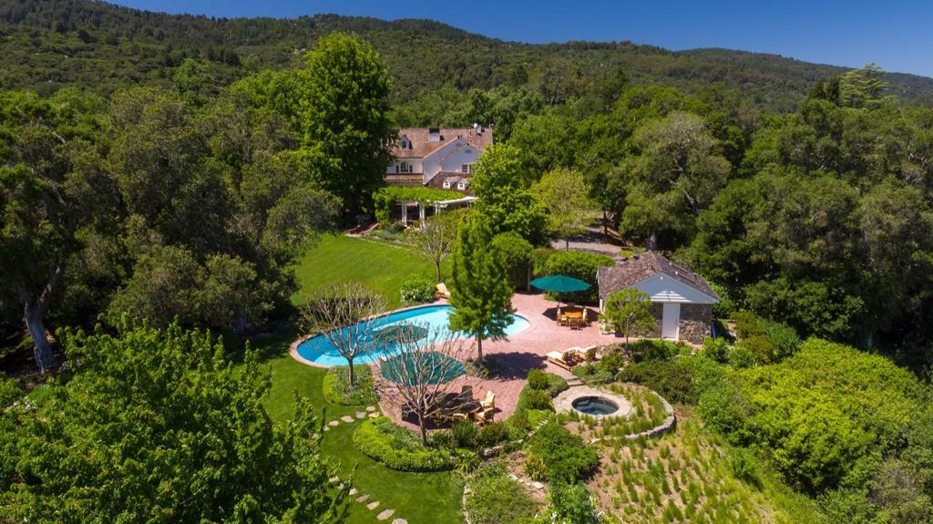 SINGINGWOOD -an Exceptional Woodside Estate offering Views, Privacy and Tranquility just minutes from Palo Alto and the center of Silicon Valley. Superbly situated on a knoll top enjoying 360 degree views bordering 1,193 acres of Stanford's Jasper Ridge Preserve. This traditional home of recent vintage is poised on over 8 beautiful acres of serene flowering gardens, woodlands and a creek, epitomizing the essence of California living. Sophisticated and infused with natural light, perfect for entertaining large gatherings of family and friends. A socially inclusive lay-out ideal for both formal and informal gatherings. Outside you'll find dining terraces, outdoor grill, swimming pool, outdoor kitchen, vegetable gardens and wisteria covered patios, all perfect for indoor-outdoor living. This unique property has everything required for a world class retreat. A rare opportunity awaits the next owner of Singingwood Estate; an uncompromising lifestyle at an outstanding value..