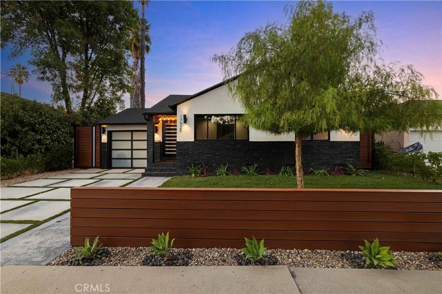 Welcome to 17929 Martha Street, an exquisite smart home where comfort, sophistication, and style are paramount. From the moment you arrive, thoughtfully curated finishes and designer touches elevate every space. The formal living room, overlooking the lush front yard, offers a calm and inviting setting for guests, while a large barn door provides a seamless transition between this cozy retreat and the expansive great room. The great room serves as the heart of the home, creating an elegant setting for dinner parties and luxury entertaining. The large kitchen is a true centerpiece, featuring abundant cabinetry, striking black quartz countertops, and an oversized waterfall island with seating for up to six. A pot filler above the stove adds both convenience and a touch of modern luxury. The expansive family room is flooded with natural light, highlighted by vaulted ceilings, large picture windows, dormer windows, and stationary glass panels that frame wall-to-wall sliders—perfectly blending indoor and outdoor living.

The primary suite is a private sanctuary, showcasing vaulted ceilings, exquisite wallpaper, and an elegant accent wall behind the bed. Dual walk-in closets with custom built-ins offer exceptional storage, while the lavish primary bathroom exudes spa-like tranquility. Featuring a dual vanity, an oversized shower with double rain shower heads and two hand sprayers, a large soaking tub, a wall-mounted towel warmer, and four skylights complemented by recessed lighting and accent chandeliers, this space is designed for ultimate relaxation. Additional accommodations include beautifully finished secondary bedrooms with large closets, a stylish half bathroom with an accent tile wall, and a secondary full bathroom featuring rain shower heads and a hand sprayer. A secluded guest suite provides flexibility for use as an office, playroom, or additional bedroom, complete with its own designer bathroom and walk-in shower. Step outside to a private backyard retreat featuring a wood deck and freshly landscaped grounds—an ideal space for outdoor entertaining or peaceful relaxation. This home perfectly blends sophisticated design with thoughtful technology, featuring a full suite of smart features including app-controlled security, video doorbells, smart thermostat, lighting, irrigation, and appliances. With voice assistant integration, enterprise-grade Wi-Fi, and universal smartphone control, this home is fully connected and future-ready.