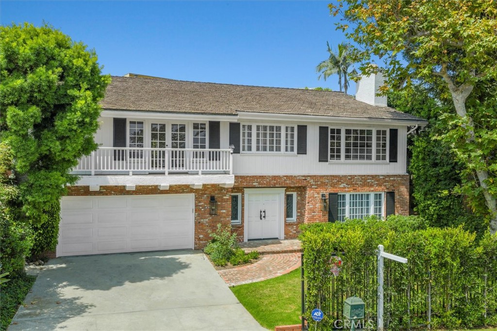 When you first arrive at this perfect family home, you will be greeted by timeless East
Coast-inspired architecture, a charming brick façade, and a welcoming gated entry. Set
in the heart of Pacific Palisades, this 4-bedroom, 3-bath residence blends classic
elegance with thoughtful modern upgrades, offering both style and comfort in a highly
sought-after location.
Inside, natural light pours into each room, highlighting wide-plank hardwood floors,
refined color palettes, and carefully curated finishes that create an atmosphere of
sophistication and warmth. The beautifully updated kitchen is a showpiece, featuring
custom cabinetry, a large center island with seating, high-end appliances, and French
doors that open to the backyard. The dining area, accented by a rich statement wall and
designer lighting, offers the perfect setting for intimate dinners or lively gatherings with
friends and family.
A spacious and airy living room serves as the heart of the home, boasting soaring
ceilings that enhance the open feel and create an impressive backdrop for both
everyday living and entertaining. The versatile floor plan includes one bedroom and a
full bath conveniently located on the main level, ideal for guests or a private home
office. Upstairs, the primary suite feels like a retreat, complete with a walk-in closet
tailored for the most discerning wardrobe and a spa-like bath with a freestanding
soaking tub, dual vanities, and striking designer tilework. Two additional upstairs
bedrooms offer space for family, work, or creative pursuits, each finished with the same
attention to detail found throughout the home.
The expansive backyard offers a peaceful escape from the bustle of city life. Mature
landscaping frames a generous lawn that invites both play and relaxation, while multiple
seating and dining areas make it an ideal space for outdoor entertaining. Whether
hosting a summer gathering, enjoying a morning coffee surrounded by greenery, or
simply letting the kids and pets roam freely, the yard is a true extension of the living
space.