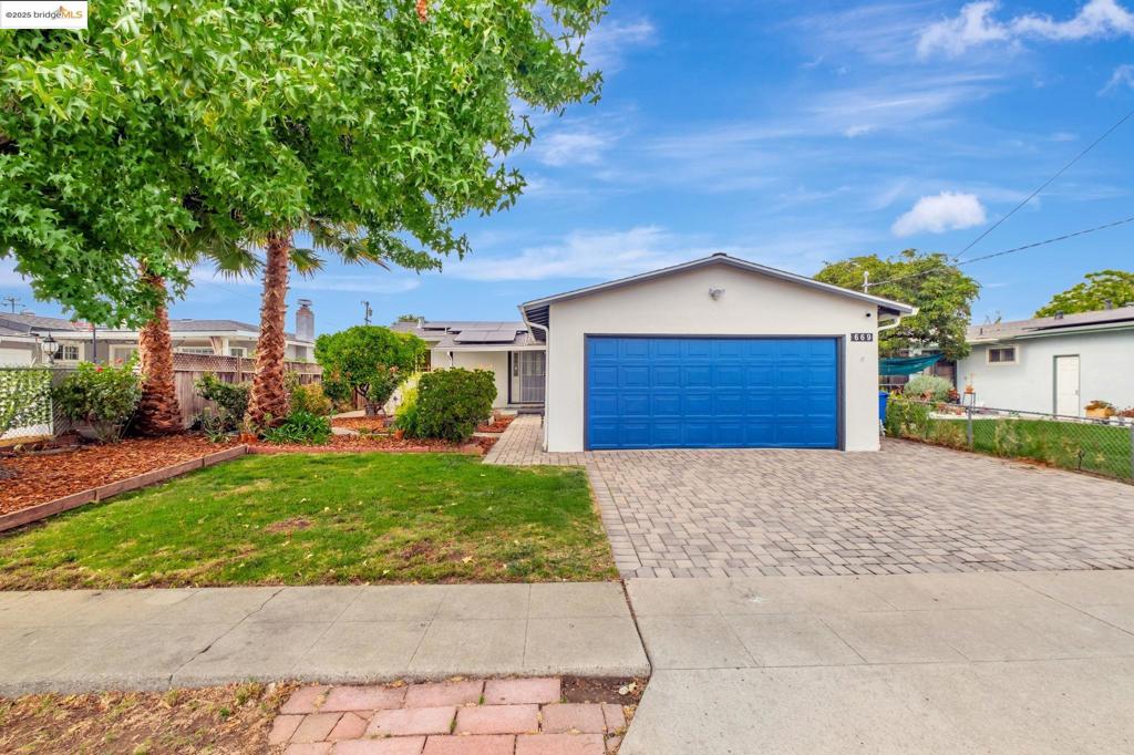 Welcome to Your Dream Home in Hayward! Step into this beautifully renovated, single-level gem nestled in one of Hayward’s charming neighborhoods. This gorgeous home radiates warmth and pride of ownership, with extensive updates that highlight the loving care of its owners. Enjoy 1,180 square feet of thoughtfully designed living space, filled with natural light that pours through every window. The open-concept layout features one large living space, 3 bedrooms and 2 bathrooms, perfect for comfortable family living. Owned Solar Panels for energy efficiency installed with new roof in 2021. Gleaming hardwood and tile floors throughout, elegant crown molding, recessed lighting, updated gourmet kitchen with quartz countertops, stainless steel appliances, including a Samsung range with an 18,000 BTU dual burner, convection oven, warming drawer, wok adapter, and a full island with pendant lighting and extra storage—ideal for culinary creativity. Finished garage with office space. Step outside to a spacious backyard, perfect for entertaining and relaxing. Host unforgettable gatherings, tend to raised garden beds, or enjoy the bounty from a variety of fruit trees. This outdoor space is a true extension of your home. Conveniently located with easy access to major highways (880/580/238), BAR