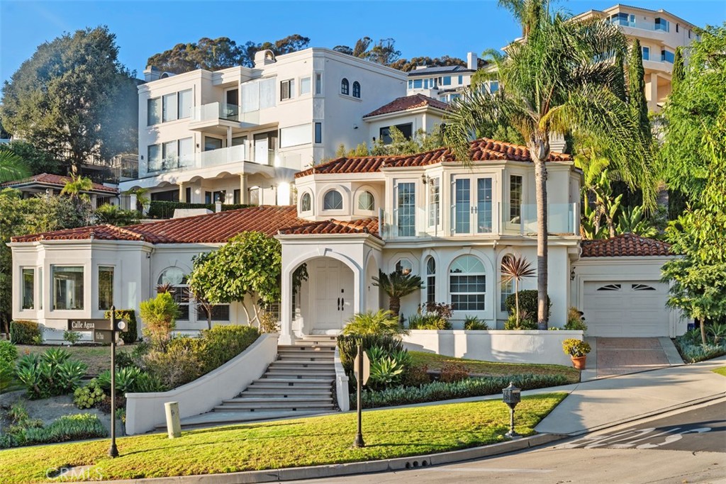 Nestled within the exclusive guard-gated enclave of Sea Pointe Estates in San Clemente, this private custom residence offers a rare blend of timeless Mediterranean design, versatile living spaces, and breathtaking coastal vistas.
The expansive open-concept floor plan showcases 4 bedrooms and 3.5 baths, including two primary suites thoughtfully designed for comfort and flexibility—one conveniently located on the main floor and another upstairs capturing sweeping ocean, Catalina Island, Dana Point Harbor, and sunset views. Two additional bedrooms on the main level provide comfort for family or guests.
Upon entry, soaring ceilings and an abundance of natural light set the stage for seamless indoor-outdoor living. The formal living and dining areas flow effortlessly together, creating an inviting atmosphere for gatherings. A generously sized family room and chef-inspired kitchen, complete with panoramic window views, make everyday living feel extraordinary.
The upstairs primary suite is a private retreat featuring an oversized layout, dual-sided fireplace, luxurious soaking tub, and a view deck perfect for enjoying San Clemente’s stunning sunsets. Outdoors, a Mediterranean-style façade frames ocean views, while a shaded fountain patio sets the tone for dining al fresco. A spacious entertaining casita with kitchenette, bath, and shower offers additional versatility for hosting or extended stays.
A three-car garage provides ample space for the car enthusiast. Residents of Sea Pointe Estates enjoy resort-style amenities including a pool and spa, tennis courts, clubhouse, and fitness center—all within moments of world-class beaches, the San Clemente Pier, charming boutiques, wine bars, and coastal dining.
