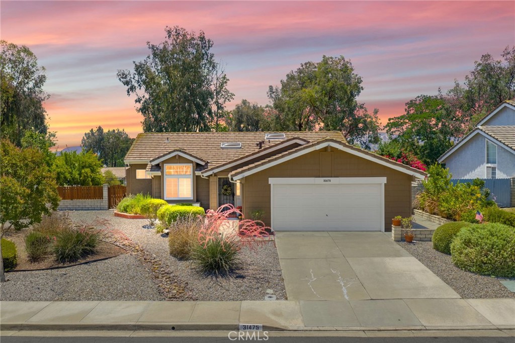 Nestled on a spacious corner lot in the desirable Villa Avanti neighborhood in Temecula, this charming single-story home boasts a rare oversized .35-acre lot with a low-maintenance yard and scenic raised garden beds. With an elevated position, this private 3 bdrm, 2 bath home features an open floorplan spanning 1,718 sq ft, highlighted by vaulted ceilings and abundant natural light. The primary bedroom features vaulted ceilings and direct access to the backyard, while the ensuite primary bathroom offers dual sinks and a tub/shower combination. Two additional well-appointed bedrooms provide flexibility and space for family or guests. Architectural angles add character and style to this inviting home. The kitchen, complete with bar seating, overlooks the living room and is equipped with a gas cooktop, microwave, oven, and dishwasher, catering to culinary enthusiasts. Laminate floors complemented by carpet flow throughout, adding warmth and comfort. Step outside through French doors and enjoy the serene ambiance from the covered patio, offering ideal outdoor relaxation. Situated above a park, this residence enjoys a prime location within walking distance to Temecula Valley High School and close proximity to shopping, library, renowned wineries, and dining options. Centrally located with low taxes and a low HOA, this Temecula gem presents a rare opportunity for comfortable, convenient living.