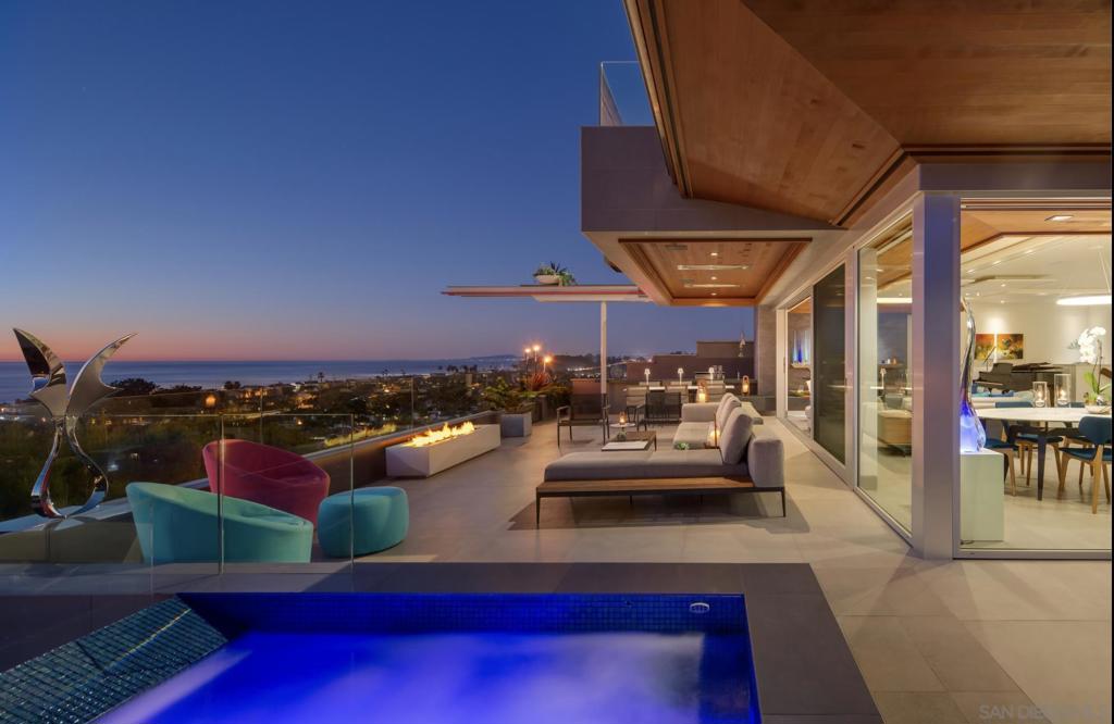 Welcome to Hale Kai—a truly exceptional coastal retreat situated on a spacious, private lot with sweeping 180-degree white-water ocean views, extending through the Del Mar Racetrack. This residence offers some of the most breathtaking vistas in all of Olde Del Mar, promising year-round sunsets that transform every evening into a picturesque experience. Designed by award-winning architect Dean Meredith, this home is an architectural masterpiece. Upon entering, you are welcomed by a custom-designed, color-infused art glass pivot front door that sets the tone for the artistic elegance throughout the home. Blue ocean views greet you immediately, complemented by modern elements and Alaskan yellow cedar soffits both inside and out, creating a warm, inviting ambiance. The great room opens to a large private entertainment deck via disappearing sliding glass doors, featuring overhead heaters and a linear outdoor fireplace for year-round enjoyment. The outdoor space also includes a custom-designed tiled spa with 180-degree ocean views, an outdoor kitchen, and a shower. Clear view glass railings ensure unobstructed ocean vistas from every angle. Inside, Miele appliances blend seamlessly into the custom cabinetry of the stunning kitchen, which boasts a two-tiered white marble island offering ample prep space and seating for dining and entertaining. A hidden prep kitchen provides additional space and storage. The main level includes two guest bedrooms, each with en-suite bathrooms and access to the ocean view deck, offering privacy and spectacular views for guests. See Supplement... The main level includes two guest bedrooms, each with en-suite bathrooms and access to the ocean view deck, offering privacy and spectacular views for guests. A dedicated laundry room and powder room complete this level. A custom-designed floating stairway with LED lights leads to the primary suite, a sanctuary featuring automatic shades and a large private deck with breathtaking 180-degree white-water views. Italian porcelain tile and French oak flooring throughout exude luxury and sophistication. The lower level, with its 11-foot ceilings, includes a great room with a bar/kitchen, two bedrooms, and two bathrooms. The home is framed for a future elevator if desired and includes designs for a pool and wine room. Ceiling speakers, each floor’s own mechanical system, Lutron-operated shades and lighting, and a security system ensure comfort and safety. Ortal Linear Fireplaces in the main great room and primary bedroom add to the home’s cozy atmosphere. Convenience and privacy are paramount at Hale Kai. The gated property includes a gated driveway and a private stairway from the lower property to street level, providing easy access to Del Mar Village, the beach, and the racetrack. The large paver driveway accommodates up to six cars, perfect for hosting guests. Advanced features and amenities include solar panels and an integrated hidden gutter system, contributing to the home's sustainability. Situated on a dead-end street, the home offers peace and privacy. Just two blocks from Del Mar Village and the beach, and three blocks from the Del Mar Racetrack, this home provides an easy 10 to 15 minute walk to local attractions. Proximity to Torrey Pines Golf Course and Torrey Pines State Reserve adds to the appeal for outdoor enthusiasts. This residence at 1956 Seaview, Del Mar, is not just a home but a lifestyle. Experience the pinnacle of coastal living with unparalleled views, luxurious amenities, and modern conveniences in this extraordinary property.