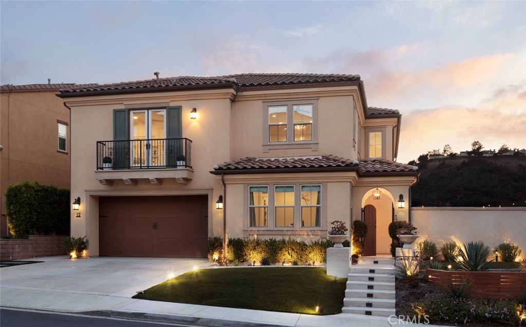 Elevated Luxury in the Hills of Mission Viejo - Welcome to 12 Cielo Prado, a rare Skyridge Collection Residence 2, built by CalAtlantic, redesigned in 2025. Available unfurnished or furnished—please inquire for pricing. On a prime corner lot with city lights and hillside views, it blends privacy, elegance, and indoor-outdoor living. In one of Mission Viejo’s exclusive hillside enclaves, this home boasts over $500,000 in upgrades. The flexible floor plan includes four bedrooms with a main-level suite, three bathrooms, a grand foyer, a bonus room, and a covered California Room. Inside, find Anderson Tuftex hardwood flooring, custom window treatments, Calacatta marble countertops, wainscoting, accent walls, designer lighting, ceiling fans, fresh paint, surround sound, a Falsken water system, and fireplaces indoors and out. The chef’s kitchen features a Calacatta marble waterfall island, full-height backsplash, shaker cabinetry with soft-close drawers, and premium appliances: Sub-Zero refrigerator, Wolf 6-burner range with griddle, double oven, microwave, Asko dishwasher, Sub-Zero beverage fridge, custom hood, and walk-in pantry. Outside, a wraparound backyard oasis with Ipe wood paneling and a water feature welcomes you. The backyard offers a California Room with roll-down shades, pre-wired flat-screen wall, linear fireplace, and ceiling fan. Enjoy a custom BBQ island, sink, wine fridge, lush landscaping, artificial turf, Sonos and Sonance sound, and a lounge alcove with fireplace. In the Saddleback Valley Unified School District, near Whiting Ranch, 241 Toll Road, Saddleback Church, Town Center Drive, and 20 minutes from Laguna Beach, this is Southern California living at its finest.