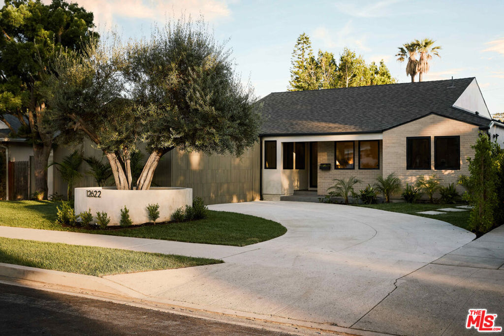 Step into a home where every corner tells a story of thoughtful design and unparalleled craftsmanship in the heart of Studio City. This completely renovated 2,690 sq. ft. masterpiece offers 4 spacious bedrooms, 3.5 luxurious bathrooms, and a seamless flow of extraordinary finishes that set this property apart from anything else. The heart of the home, a chef's kitchen, features exquisite marble countertops and a professional-grade Jenn Air 48" appliance package truly a showstopper for culinary enthusiasts and entertainers alike. This is not just a kitchen; it's a work of art, designed to inspire. The family room is an architectural statement, with stunning custom wood paneling that adds warmth and texture to the space, creating a sophisticated yet inviting atmosphere. The design continues in the primary bedroom, where wood paneling makes a bold yet tranquil statement, enveloping you in comfort and style. Each bathroom is an oasis, showcasing custom stonework that elevates the home's spa-like ambiance every detail, from the flooring to the vanities, speaks to a level of design rarely seen in today's market. With 2,690 sq. ft. of meticulously designed living space, this home harmonizes luxurious materials with unparalleled craftsmanship. The Austrailian inspired backyard equipped with a StruXure aircraft aluminum grade pergola and smart system louvers allows you to enjoy the outdoors in the shade or sun with a click from your smartphone. It's not just a place to live; it's a work of art designed for the discerning homeowner who appreciates timeless beauty and modern sophistication. A truly one-of-a-kind home. Don't miss the chance to own this extraordinary property just a short distance to the new Sportsmens Lodge shopping center with the likes of Equinox, Erewhon, Sugarfish and Uovo.