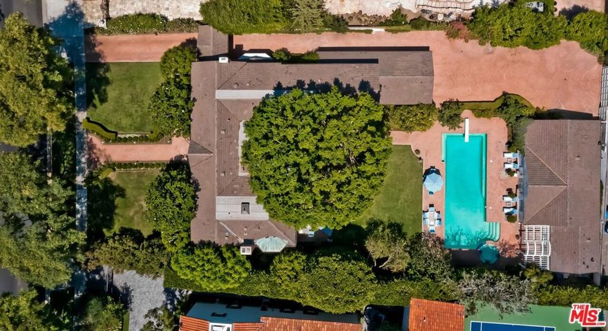 Presenting a rare and refined 2sty brick-front Georgian Traditional estate exhibiting extreme curb appeal and sited on over 24,000 sq ft of lush land on the most desirous of 900 blocks in all of Beverly Hills. This charming and elegant home reflects years of sensitive updating and features wood floors, French doors, mouldings, and fabulous built-ins. Gracious 2sty reception foyer with dramatic staircase. Designed with the entertainer in mind, a huge living room flows to a generous family room with service bar and fireplace opening to the deep grounds with patios, lawns, pool, spa, cabanas, garages, rear motorcourt, tremendously large refrigerated wine cellar, BBQ center, and guest house (living room, full kitchen, bedroom, bath). 2sty atrium with exquisite Deco-era glass ceiling from France. Splendid paneled den/library with fireplace downstairs along with an additional office space upstairs. A true cook's kitchen containing top stainless appliances and great storage opens to a magnificent breakfast room. Mammoth owner's bedroom suite with dual-sided luxurious bathroom and two big walk-ins. 3 other spacious bedroom suites upstairs and a 2-room housekeeper's quarters downstairs. Available for the first time in 38 years, this is a once-in-a-generation opportunity to acquire the best that Beverly Hills has to offer.