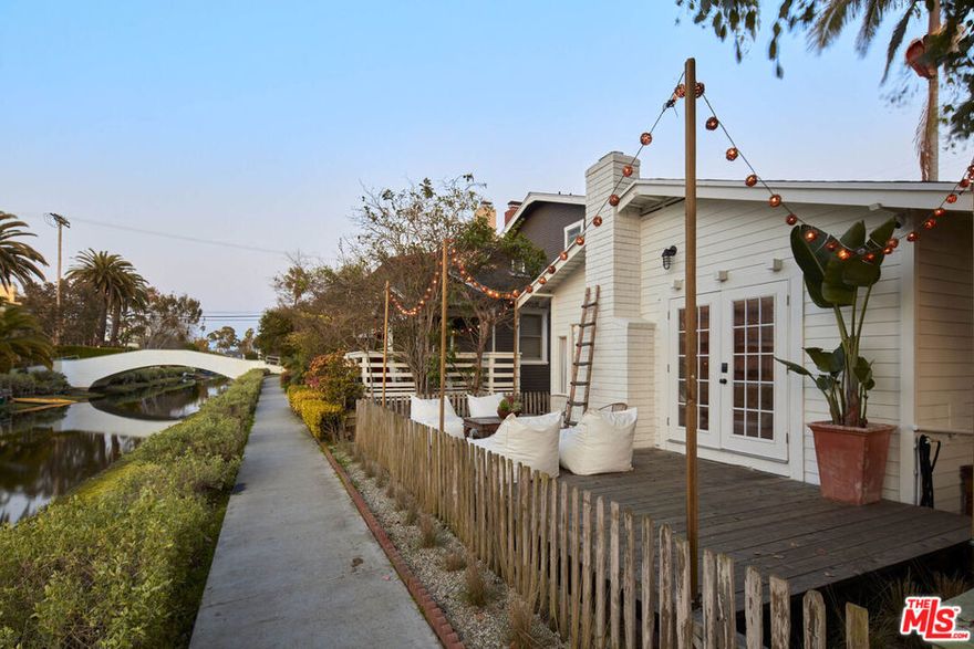 Incredible Venice Canal Jewel Box - Tucked along the iconic Venice Canals, this charming bungalow is a rare offering - a true beachside retreat and an ideal pied-a-terre in one of Los Angeles' most coveted coastal enclaves. With its serene setting and timeless charm, this thoughtfully updated home offers a unique slice of SoCal living just moments from the sand. Step inside to find a light-filled open living and dining space, warmed by a gas fireplace and framed by French doors that open to a spacious canal-front deck. It's the perfect place to lounge, entertain, or dine al fresco while enjoying breezes off the Pacific and magical sunsets reflected on the water. The home has been tastefully updated with new vinyl plank flooring, modern appliances, fresh interior and exterior paint, stylish lighting, and a tadelakt bath that adds a bespoke designer touch. The French-style front door and updated finishes bring a crisp, coastal feel throughout. Outside, the fenced yard features newly landscaped grounds and a grassy area perfect for gardening, relaxation, or creative expansion. Two parking spaces add convenience in this high-demand location. Whether you're seeking a weekend getaway, a low-maintenance home, or a property with future potential, this canal-side bungalow delivers. Just a short stroll to Abbot Kinney, the beach, parks, and top dining and shopping, it's a rare opportunity to own a peaceful yet vibrant slice of Venice.