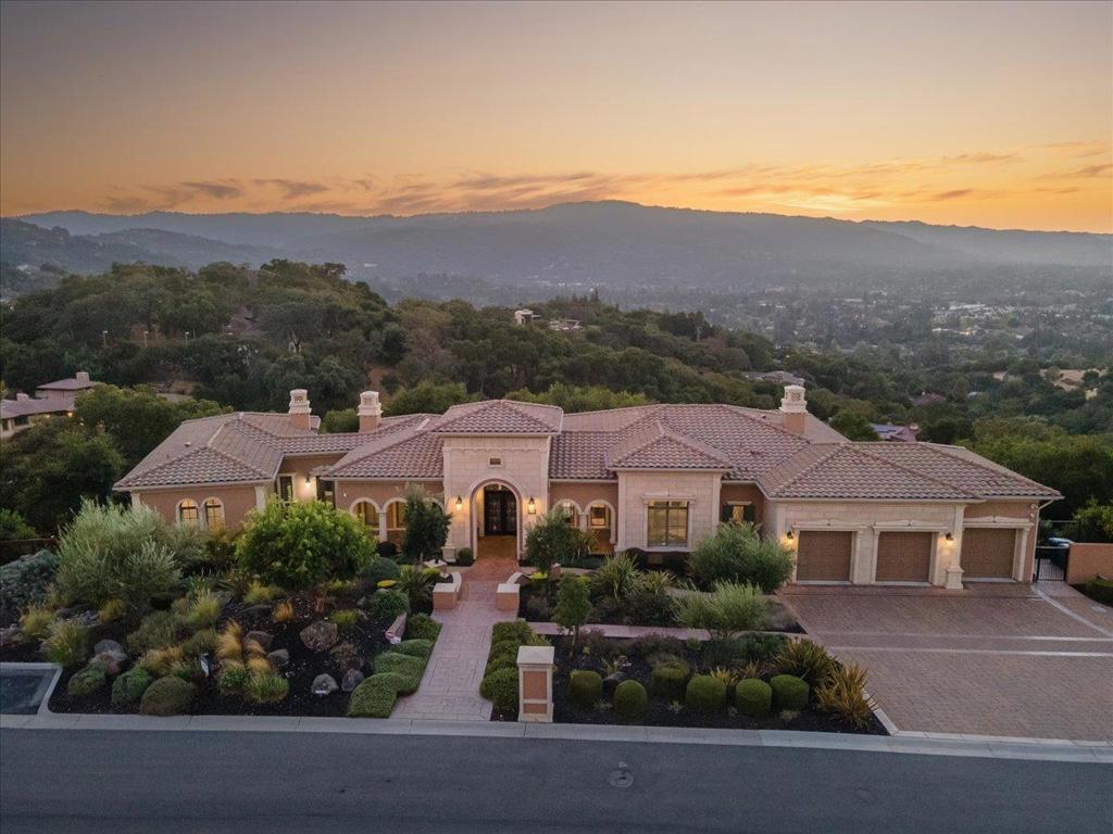 Magnificent Mediterranean Estate perched on 1.72 acre's in the Highlands Development with spectacular views of Los Gatos, Western Hill's,  Mountain Winery, Cupertino Foothills, & East Bay. As you enter the wrought iron & glass doors you will find a formal entrance, formal dining room, formal living room with cast stone gas fireplace, box beam ceiling, Picture view window and french doors to exterior deck. There are 5 bedrooms with en-suite baths, 0ne 1/2 bath, including 2 large primary suites, one on each level. Spacious gourmet chef's kitchen with Thermador commercial grade appliances, 3 ovens, 6 burner gas cook-top, 2 dishwashers, wine fridge, warming drawer, and a huge center island. Attached family room with built-in cabinetry, box beam ceiling, built-in speakers, gas fireplace, and stack stone accent wall. Indoor laundry room with wash basin. Separate office with privacy glass doors. All bath surfaces are stone, granite, onyx, and travertine. Walk-in closets all with custom built-ins. Lower level Theater with screen and projector. Temperature controlled wine cellar with brick & wood beamed ceiling. Lower level game/media room with built-in speakers, 2nd butlers kitchen with rare Egyptian stone. Media rack, whole house Savant system, wood & stone floors. The list is endless!