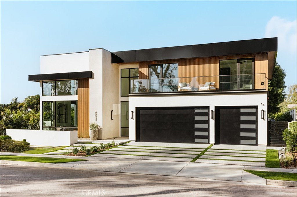 Set within a tranquil equestrian neighborhood overlooking Newport’s Back Bay, The Mesa Estate embodies refined craftsmanship and effortless luxury. Crafted by Burkhart Construction and designed by Grace Blu, this 3,585-square-foot residence offers a seamless blend of sophisticated indoor-outdoor living. Soaring 20-foot+ ceilings and bold architectural lines welcomes you, while expansive windows and La Cantina sliding glass doors seamlessly dissolve the boundary between interior and exterior, flooding the space with natural light. The chef’s kitchen is a masterpiece of style and function, featuring leathered quartzite countertops and professional Wolf appliances, including a six-burner range with an infrared griddle. Designed for both entertaining and relaxation, the private backyard boasts a pool and spa, covered dining, fire pit, outdoor kitchen with BBQ, overhead heaters, and multiple seating areas—perfect for enjoying the coastal climate. The primary suite is a serene retreat, complete with a private balcony, walk-in closet, and spa-like bath finished in elegant Taj Mahal leathered stone. Three bedrooms reside upstairs, while two additional bedrooms, an office, powder room, and two full baths on the main floor provide flexible living options. Additional features include a laundry room, home gym, Savant smart home system, wine fridge, and a three-car garage with ample driveway parking. Just minutes from the beach, Back Bay trails, Fashion Island, and top rated schools, The Mesa Estate offers an unparalleled blend of modern design and relaxed coastal living.
