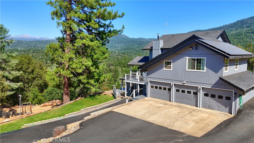 Enjoy breathtaking High Sierra backcountry views from this beautifully remodeled 5,292 sq. ft. home on 14.14 private acres. With 7 bedrooms (1 used as office) and 4.5 baths, this spacious property offers flexible living with a full downstairs suite (Approx. 1200 sq.ft.) featuring 2 bedrooms, 2 baths, full kitchen, and living area complete with separate entrance and a lockable interior door for privacy. Potential Vacation Rental. Upstairs includes 5 bedrooms, 2.5 baths, and a fully updated kitchen with reverse osmosis drinking water, newer appliances, and modern finishes. Recent upgrades include a full interior remodel, newer HVAC system for downstairs, new windows throughout most of home, 100% LED lighting, exterior paint, and Trex-like decking to take in the views. A 10x16 shop, repaved driveway, shared private well, and 30kw commercial generator add practicality and peace of mind. Owned solar keeps energy costs low. Located just minutes from downtown Oakhurst with easy access to Bass Lake and Yosemite, and Chukchansi Casino. A rare blend of comfort, versatility, and mountain living!