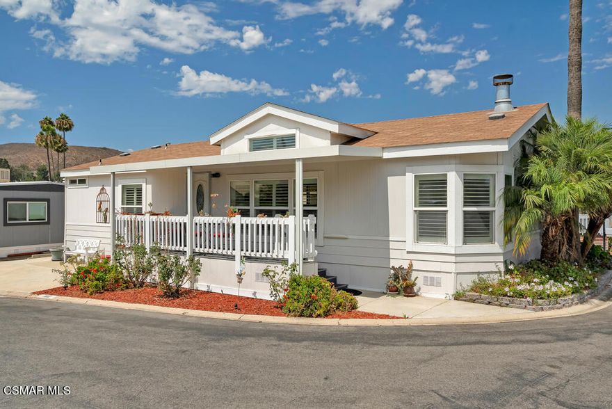 Welcome to this stunning and meticulously well-maintained 2 bedroom, 2 bath home built in 2004 and ideally situated on a desirable corner lot near the front of the park in a vibrant 55+ senior resort style mobile home park. Step inside to an open light and bright airy floor plan featuring soaring cathedral ceilings, a cozy fireplace, dual paned windows, beautiful plantation shutters, and updated laminated wood flooring that adds warmth and modern style throughout. The inviting living and dining areas are perfect for relaxing and entertaining. The spacious kitchen offers abundant cabinetry, generous countertops, breakfast bar and nook, and washer/dryer closet. The primary bedroom suite offers a large walk in closet and private ensuite bathroom with double vanities and large shower. The second bedroom and bath features a relaxing tub for soaking. Additional high-lights include a new AC unit and thermostat installed in 2021 for year round comfort. Outdoor shed for extra storage. And a delightful front porch to sit out and relax. Close by this vibrant community offers a wealth of amenities including a sparkling pool and spa, Clubhouse with pool table, ping pong and card tables, fitness center, A full kitchen, putting green and many hosted events to mingle. A Dog Run. AndRV parking available too. If you are looking for a low maintenance living in a friendly active 55+ community, this home is a must see!!