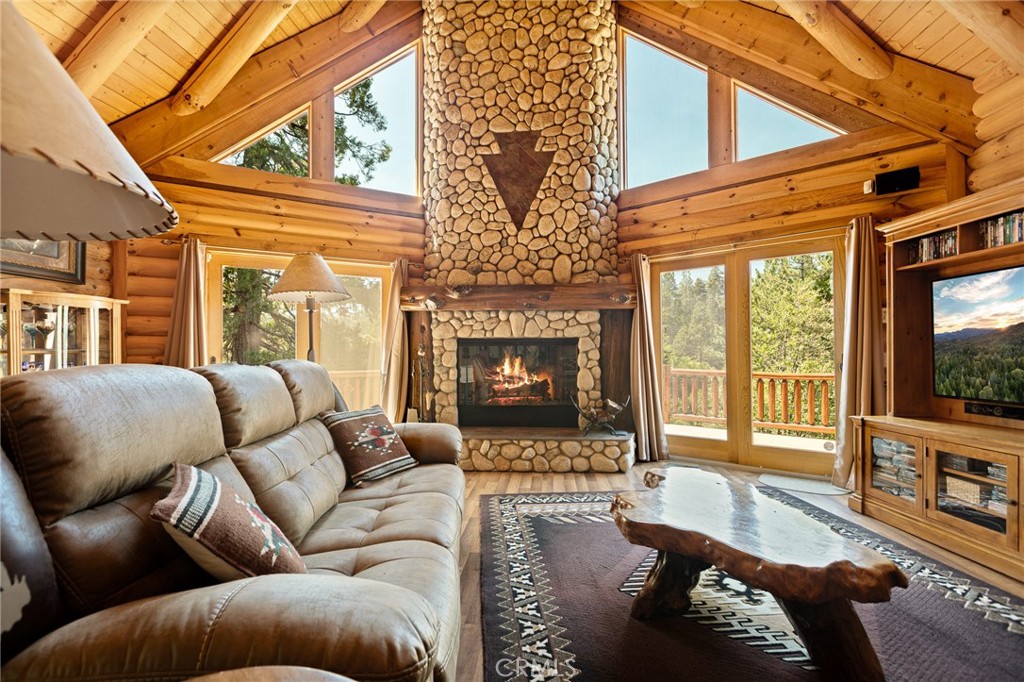 YOU WILL FALL IN LOVE with this Absolutely Magical Over 4100 sf LUXURIOUS LOG CABIN Surrounded by SUPER LUSH Pines & Cedars!! Just Built in 2009, it Doesn't Need any Updating at all!! Just Move on In & Enjoy! The Towering Walls & Ceilings Made of REAL LOG with the Stunning Floor to Ceiling Stone Fireplace with Nostalgic Arrowhead Symbol Will Make You Say WOW! Sooo Cozy & Sooo Welcoming!!! There is Just the Perfect Amount if Natural Light Beaming in Through the Oversized Windows Throughout! The Craftsmanship Here is Simply OUTSTANDING!!! The Kitchen is Open to the Living Room and Master Bedroom on the Main Level, Compete with Walk-in Closet, Double Sinks and Separate Soaking Tub. Upstairs are 2 More Oversized Bedrooms (one with a Private Deck for Coffee in the morning!) with a Gorgeous Bathroom! The Loft is Currently Being Used as an Office. Downstairs is a HUGE Family Room with Sitting Area, Serving Bar, Pool Table & Access to Hot Tub on the Wraparound Deck! The Extra Lot Next Door Included in Sale Gives the House Nearly Half an Acre to Sit on... And the Best Part is How the Gorgeous Trees all Around Give the Greatest Sense of Privacy Here!!! Meadow Bay Dock Also Available for Extra $$! Call for Details!