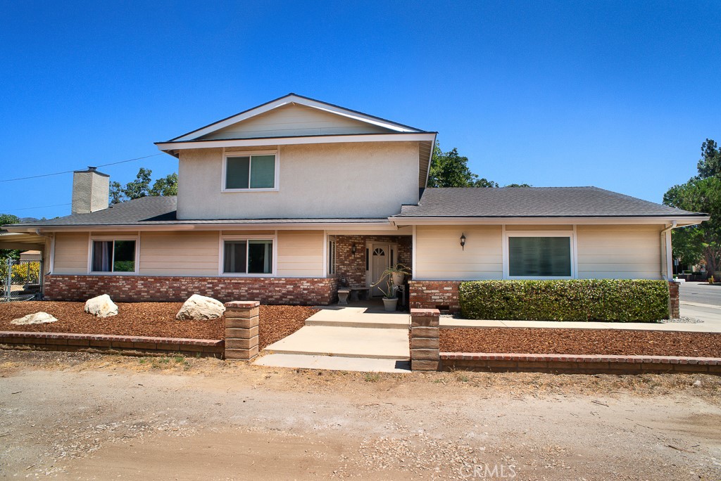 RARE OPPORTUNITY! FIRST TIME ON THE MARKET IN 35 YEARS!!! THIS METICULOUSLY UPGRADED PROPERTY OFFERS AN UNPARALLELED LIVING EXPERIENCE ON AN EXPANSIVE 21,500+ SQ. FT. OASIS. THE MAIN RESIDENCE IS A BEAUTIFULLY APPOINTED 4 BEDROOM, 3 BATH HOME DESIGNED FOR COMFORT AND ELEGANCE STEP INTO A GRAND FOYER FEATURING CUSTOM TILE FLOORING AND RECESSED LIGHTING, SETTING THE TONE FOR THE QUALITY WITHIN. THE GOURMET KITCHEN IS A CHEF'S DREAM WITH UPGRADED CABINETRY, GRANITE COUNTERTOPS, AND A CONVENIENT CENTER ISLAND. BAY WINDOW OVER SINK PROVIDING A WIDER, MORE PANORAMIC VIEW OF THE OUTDOORS. ENJOY THE FLEXIBILITY OF A DOWNSTAIRS ROOM, PERFECT FOR A BEDROOM, OFFICE OR DEN WITH OWN BATH. RELAX IN THE COZY FAMILY ROOM WITH A CHARMING BRICK FIREPLACE, OR ENTERTAIN IN THE FORMAL DINING AREA WITH WINDOW SEAT. VAULTED CEILING WITH EXPOSED WOOD BEAMS ADD ARCHITECTURAL INTEREST, WHILE ABUNDANT WINDOWS WITH TASTEFUL TREATMENTS FLOOD THE HOME WITH NATURAL LIGHT AND OFFER PICTURESQUE VIEWS OF THE LUSH FRUIT AND TROPICAL TREES. MODERN COMFORTS INCLLUDE NEW AIR CONDITIONERS AND HEATERS FOR YEAR-ROUND CLIMATE CONTROL. THE PRIMARY BEDROOM BOASTS A WALK-IN CLOSET, AND A UNIQUE TRASH CHUTE FROM UPSTAIRS DIRECTLY TO THE SEPARATE DOWNSTAIRS LAUNDRY ROOM ADDS CONVENIENCE. STEP OUTSIDE THROUGH FRENCH DOORS TO DISCOVER A PRIVATE PARADISE! THE LUSH LANDSCAPING FEATURES A BOUNTIFUL ARRAY OF 18 MATURE AVOCADO TREES, ALONG WITH PERSIMMONS, MINNEOLA ORANGE AND MEYER LEMON TREES, CREATING A SERENE AND PRODUCTIVE ENVIRONMENT. UPGRADED BATHS, LARGE BEDROOMS WITH BUILT IN SHELVING, LOTS OF STORAGE, ATTACHED 3 CAR GARAGE. THIS PROPERTY STANDS OUT WITH A SEPARATE, PRIVATE 2 LARGE BEDROOM, 2 BATH ADU. THE ADU OFFERS ITS OWN PRIVATE ENTRANCE, A 2 CAR CARPORT, CUSTOM WINDOWS, GOURMET KITCHEN, AND A COMFORTABLE LIVING ROOM - IDEAL FOR EXTENDED FAMILY, RENTAL INCOME, OR A DEDICATED HOME OFFICE SUITE. THIS IS A MUST SEE!