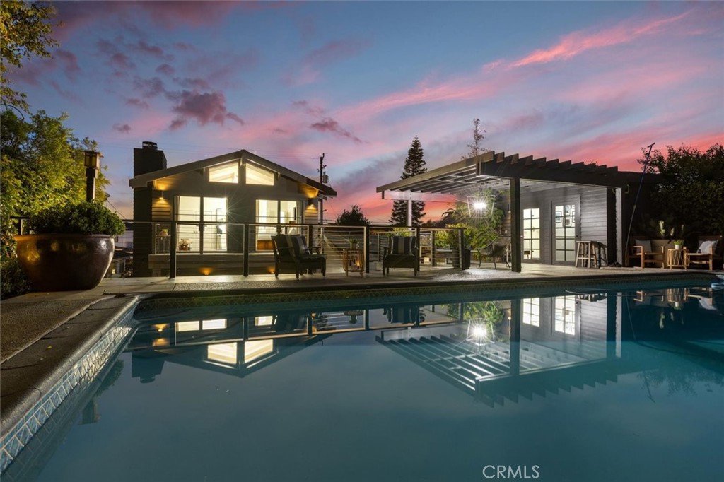 If you are looking for a run of the mill cookie-cutter home in Manhattan Beach, perhaps you should look elsewhere. If on the other hand, you want a home filled with the personality and style that meets your shifting moods, you will love the way this remodeled luxury residence lives. The feeling is inspired from the moment you open the gate and see the trussed beam front porch and private shrouded front yard, reminiscent of classic Pasadena craftsman homes. The first impression at the front door is the great room with island kitchen and black steel doors leading to one of the vignetted exterior yard spaces, seamlessly spreading between the home and the detached two-car garage, which has cleverly been converted into indoor outdoor space, with a glass accordion door that opens 15 feet (and is easily converted back). Lustrous hardwood floors accent the living space. The sparking white cabinets in the chef's kitchen, with its complete array of state of the art appliances, are accented by dark stone counters and pulls. Natural light pours in and drenches the interior with warmth through an array of glass windows and doors. There are three bedrooms on the ground floor with two full baths. Plus a private family room at the back of the home, that is highlighted by a wood burning fireplace, and access to a super cool and very private yard. And there is so much more. Up a flight of stairs on the exterior, is a magical elevated deck AND nestled perfectly at the back of this immense 50 X 150 lot is an amazing elevated pool. As you can imagine, the atmosphere at night is perfectly cerebral; your family and guests alike will discover all of the dreamy spaces on the inside and outside of this home. If it feels as though we are jumping inside, then outside, then back again, this is how the home reveals itself, opening like a flower, to display the wonders within. And the greatest spot of all may be the Primary suite sanctum, perched alone on the second floor, with vaulted wood beam ceilings, and crackling fireplace, two walk in closets, and a luxurious bath with old fashions steeping tub, separate shower, and dual lavs, all lavishly appointed. The best part may be the view from the primary deck across the yard to the pool and pool deck, which are at the same elevation - like the elevated feeling you get throughout this truly unique and glorious home. So convenient to shopping, award winning schools, transportation and of course the most pristine beaches on the planet!