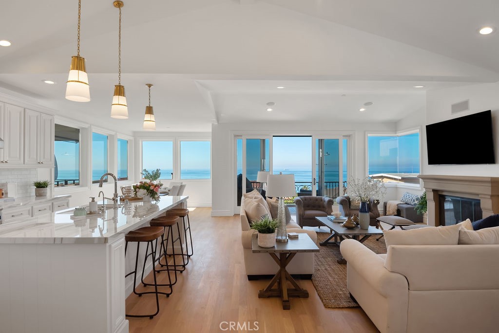 Beachside living in Manhattan Beach Sand Section with breathtaking, unobstructed ocean views. This fully furnished three bedroom residence is positioned on a walk street just mere steps from the beach. The top floor unveils an exquisitely designed open concept, where an expansive kitchen, dining area, and a grand living room converge seamlessly, all framed by a warm and inviting fireplace. Boasting three nicely appointed bedrooms, including a lavish primary suite with balcony, adorned with double sinks, a gorgeous walk-in shower, separate soaking tub, and generous walk-in closet. In addition, the residence was completely remodeled in 2022 and includes a 3-stop elevator, separate laundry room, air conditioning and attached 2-car parking garage with an additional carport space. This home will allow you to experience the coastal dream in its purest form and entertain with ease. Conveniently located moments from North Manhattan Beach with dining options, fitness studios and shopping nearby.