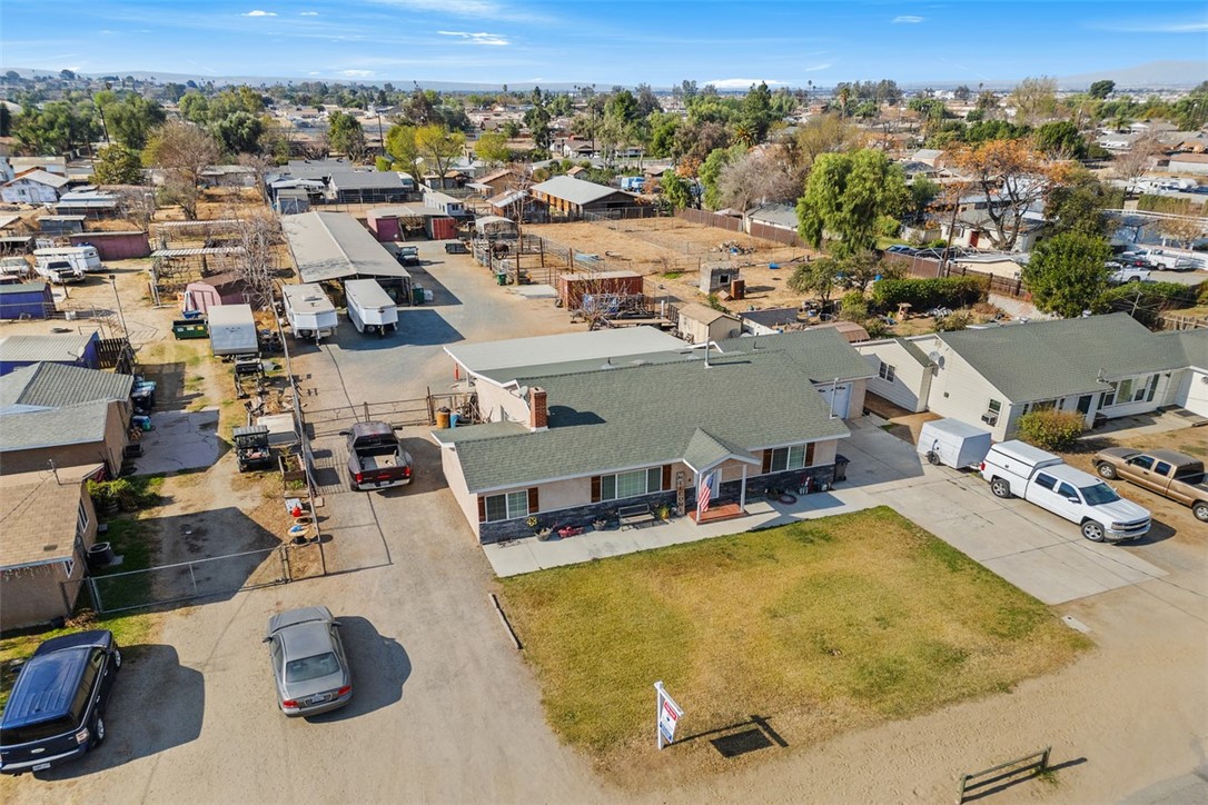 Experience Western equestrian living, uniquely done in the one and only town of Norco, California! Featuring over half an acre (27,007 sq ft) in the sought-after community of Norco—also known as “Horsetown USA”—this spacious property is perfectly equipped for horse lovers and those seeking a blend of rural charm and suburban convenience.
This community, whose motto is 'City Living in a Rural Atmosphere', is centered around outdoor living, animal keeping and of course, horses! With miles of riding trails throughout this part of Norco, this property is situated close to the heart of downtown. Ride right out of your gate and up 6th Street to meet friends, grab refreshments, stop off for a game of pool or some shopping. There are many riding arenas and parks scattered throughout Norco. You are close to the 80 acre George Ingalls Equestrian Event Center and not far from the Hidden Valley Wildlife Preserve.
The mid-century touches in this comfortable 4 bedroom, 2 bathroom home include original hardwood floors and arched doorways. It offers comfort and functionality. Upgraded double pane windows, roof and heating and A/C system keep you comfortable. The A/C compressor and fan in the attic were replaced this summer. Overlooking your spacious and FLAT back yard is an nearly 800 square foot patio, with gas, water and electric nearby if you decide to add an outdoor kitchen. For your horses: five covered 24' x 24' stalls, offering your horses shade and shelter year-round. With plenty of room for riding, trailer access, and future expansion, this property is ready for you, your horses and your vision. There is a also clean out for your RV. Combining lifestyle, location, and value, this property offers you the opportunity to own a slice of Norco paradise!