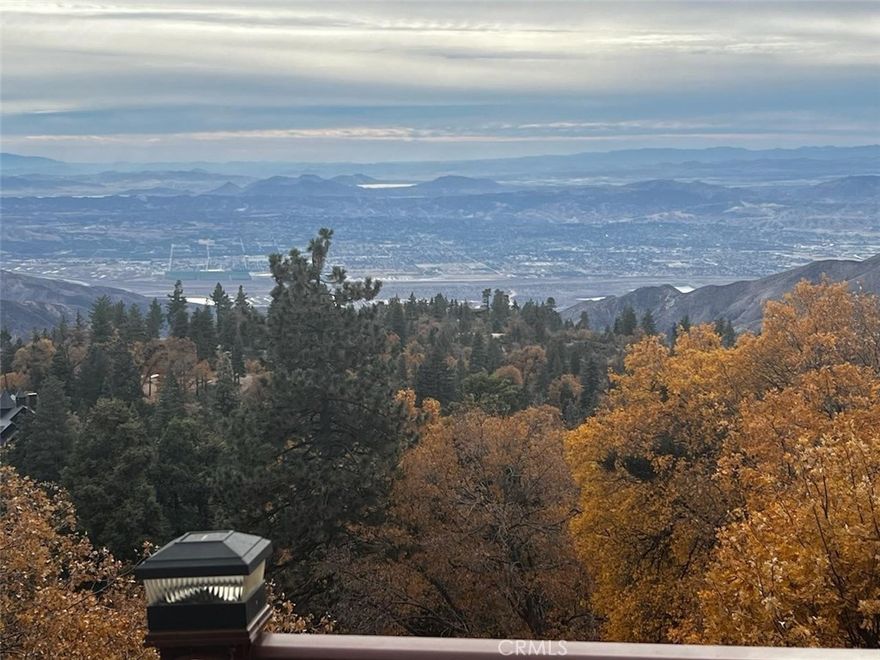 Ever wonder why this area is called 'Rim of the World'? Check out the VIEW on this amazing offering in Running Springs and you'll understand. From the ocean to the Anaheim Hills to Lake Matthews, you can take it all in through the gorgeous windows of this wonderful mountain home. At night, enjoy the transition to sunsets and city lights. With no houses behind you, these views will be yours for decades too. 

Having been custom built by its current owner, this beautiful home has all the signs of love and care and virtually no signs of wear and tear. It's ready for you to come with your suitcase and start making memories. There's a bedroom and a full bathroom on each floor for everyone's privacy and space. The main floor features vaulted tongue and groove ceilings, picture windows and a warm wood stove. Upstairs is currently the primary retreat with a luxurious bathroom fit for your relaxation. The lowest level of the house is a bonus den space that is currently a game room with wet bar and pool table. This is where the fun happens on game day! You'll also find the third bedroom and bathroom here. Two decks to absorb the views day or night also are featured at 2477 Spring Oak. You'll be happy to have both central A/C and furnace to keep the house comfortable in all seasons.

Don't miss this exceptional home on your next tour!