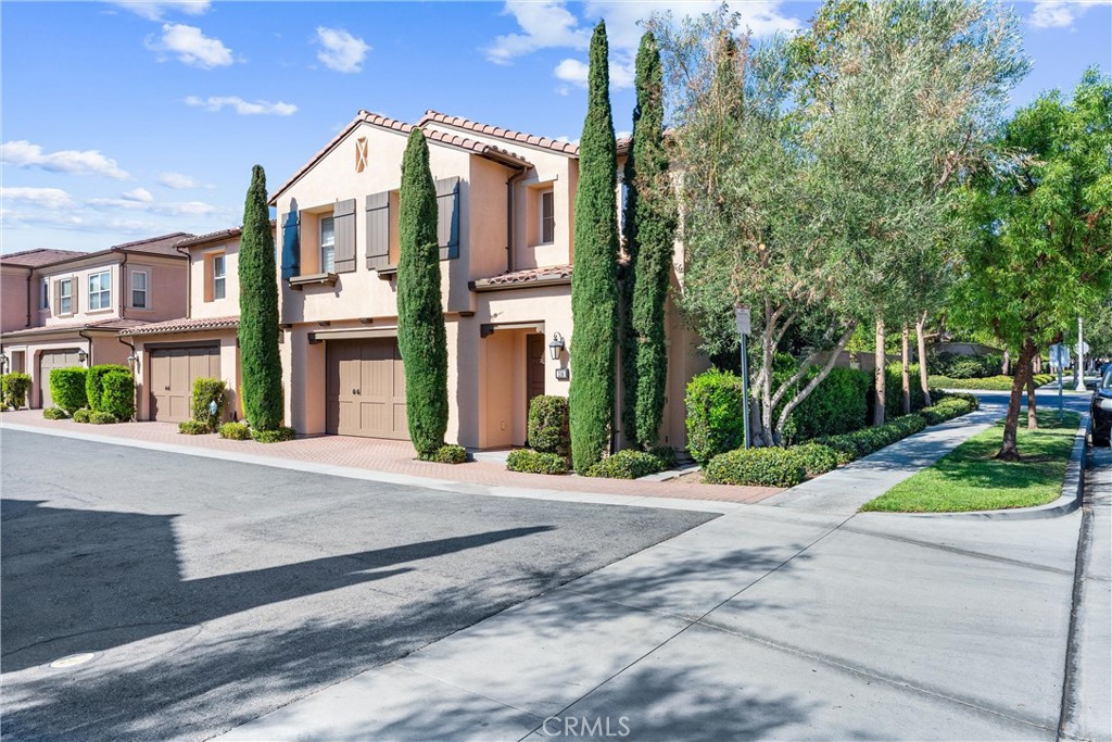 Welcome to this stunning 3 bedroom, 2.5 bathroom end-unit condo in the highly sought-after Stonegate community of Irvine. Offering 1,777 sq. ft. of light-filled living space, this home blends modern upgrades with timeless style—just steps from the neighborhood Egret community park . An extra-wide front door opens to a grand foyer with soaring ceilings, fresh paint, and a staircase to the second floor. Off the hallway, you’ll find a spacious storage closet, direct garage access, and a half bathroom. The main level features French oak engineered hardwood floors, wide plantation shutters, crown molding, recessed lighting, and an open-concept layout. The chef’s kitchen boasts a new stainless steel refrigerator, gas stove, double basin sink, extensive counter and cabinet space, a breakfast island, and a unique magnetic wall. The kitchen flows seamlessly to the living room and dining area, where a sliding door leads to the private backyard with lush landscaping and tall walls—perfect for entertaining or relaxing. Upstairs, the primary suite showcases peaceful backyard, park, and mountain views, along with a walk-in closet outfitted with custom Closet World built-ins. The spa-like bathroom offers a soaking tub, walk-in shower, and dual-sink vanity. Down the hall is a convenient laundry room with washer, dryer, storage, and a folding counter, plus another full bathroom with dual vanities and a deep tub/shower. Two additional spacious bedrooms complete the upstairs—one with a chandelier, the other with a custom built-in desk, shelving, and wood-accent wall. Additional highlights include dual-zone AC with smart Nest thermostats, double-paned windows, and an attached 2-car garage. Set within the vibrant Stonegate community, residents enjoy access to resort-style amenities including multiple pools, spas, parks, playgrounds, and sports courts—all within minutes of top-rated Irvine schools, shopping, dining, and freeways. Irvine also offers a unique bike and hike trail system connected by walkway bridges so you never have to cross a road. This exceptional end-unit home offers comfort, style, and convenience in one of Irvine’s most desirable neighborhoods.