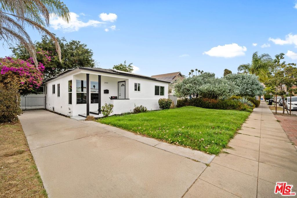 Nested mid-block in a peaceful and quiet Los Angeles neighborhood. This beautifully reimagined home captures the essence of comfortable living while embracing modern updates. The main residence features 3-bedroom, 2-bath, including a dedicated laundry room. Bright and airy open floor plan with large windows, seamlessly connecting living and dinning area. The fully equipped kitchen boasting granite countertops, stainless steel appliances, and ample storage perfect for both everyday living and entertaining. Step outside, a large backyard with build-in BBQ area, perfect for gathering or simply enjoying the SoCal sunshine. The property's highlight is the detached garage conversion guest unit, privately set at the end of a long driveway. This self-contained space offers a kitchen, dining area, living room, bedroom, bathroom, and in-unit laundry. Perfect for extended family, visiting guests, or as a potential income-producing unit, it brings outstanding versatility and value. Easy access to Downtown LA, major freeways 10&110, 8 minutes to USC, commuting is effortless.