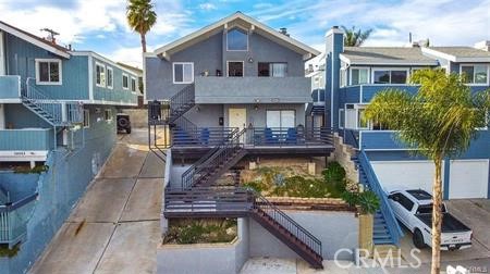 Super duplex opportunity in the heart of Lantern Village, Dana Point! This property features a 3-bedroom, 2-bathroom upper unit all on one level, and a 2-bedroom, 2-bathroom lower unit, also all on one level. Both units include fireplaces in the living rooms and ceiling fans. The upper unit offers vaulted ceilings and a peek-a-boo ocean view from the deck. The 3-bedroom unit comes with a 2-car garage, while the 2-bedroom unit has a single-car garage. Both garage doors have been replaced and include remote openers. Each unit has inside laundry hook-ups.
The upstairs unit has been fully remodeled, making it ideal to rent at top market rates or as a prime opportunity for an owner-occupied duplex, paired with a very stable long-term tenant downstairs. Major upgrades were completed in December 2020, including new windows, decking, roof, exterior paint, and gutters.
Located close to Downtown Dana Point, shopping, restaurants, parks, the harbor, beaches, and the ocean. Also convenient to public transportation, freeway access, and the train station. The lower unit is occupied by a long-term, reliable, and friendly tenant who is paying below market rent.
Additional upside: potential to add two ADUs without extensive city approvals (buyer to verify with the City).