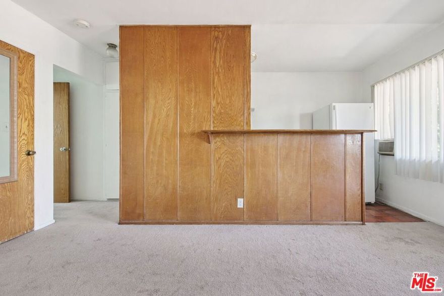 Incredible location in the heart of Hollywood, just two blocks from Sunset Blvd, and hot spots like Iki Nori, Superba, and Mother Wolf! This top-floor unit is the quintessential Hollywood studio, featuring a classic 1950s bathroom and a cozy living room with warm wood paneling. The living space connects to the kitchen where you'll find a tall counter - perfect for dining or working from home. The kitchen features a double sink, 4-burner range with oven, and a refrigerator with freezer, as well as under-cabinet storage, floating shelves, and a rack for hanging pots and pans. An oversized window lets in natural light and looks out at the blue skies and palm trees. A conveniently located community laundry room can be found on the first floor, and each unit has their own private mail box. Situated on a corner lot surrounded by single-family homes and the local police station, this quaint two-story complex offers just 13 units. You can grab coffee at Groundwork, catch a show at the Hollywood Palladium, and get groceries at Trader Joe's - all without leaving your neighborhood! Convenient access to the Metro and 101 freeway make it easy to commute or explore all that LA has to offer! Available for immediate move-in.