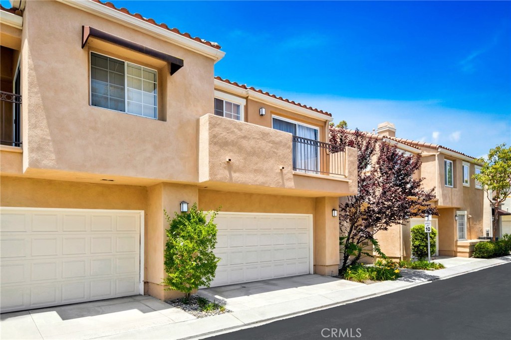 Tucked into the highly sought-after Chandon community within Marina Hills, this beautifully updated 2-bedroom, 2.5-bath townhome is the perfect blend of style, comfort, and location for the on-the-go lifestyle. Step through the gated front courtyard with flagstone entry into a light-filled home featuring travertine flooring, recessed lighting, and a striking stacked stone fireplace in the living room. The chef-inspired kitchen boasts stainless steel appliances, granite countertops, and beautiful, classy cabinetry. Upstairs, both bedrooms offer en-suite baths, with the primary suite showcasing vaulted ceilings and a tastefully remodeled bathroom and vanity. Dual-glazed windows and sliding doors throughout provide energy efficiency and tranquility. Enjoy outdoor living with a spacious flagstone patio backing to a lush greenbelt — perfect for morning yoga, evening wine, or entertaining friends after a day at the beach. Washer, dryer, and refrigerator are included, and the extra-large two-car garage offers plenty of storage for bikes, boards, and gear. Just steps from the resort-style pool and spa, tennis courts, scenic parks, and hiking and biking trails. Plus, world-class beaches, shopping, and dining are just minutes away. Whether you’re hitting the trails, catching waves, or just soaking up the Southern California sun — 5 Chandon is your launchpad for the ultimate active lifestyle.