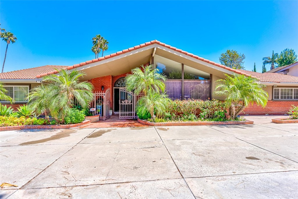 This home is nestled in the heart of Sunny Hills Estates near Laguna Lake, Fullerton Loop’s hiking, biking and equestrian trails. Situated on a generous lot, the property offers a spacious floor plan, beautifully landscaped grounds, and exceptional privacy—perfect for both relaxing and entertaining. Step into your private resort-style backyard featuring a sparkling pool with water features, expansive paver patio, and lush landscaping. Whether you're entertaining under the umbrella-shaded dining area or relaxing poolside, this backyard is designed for unforgettable California living.