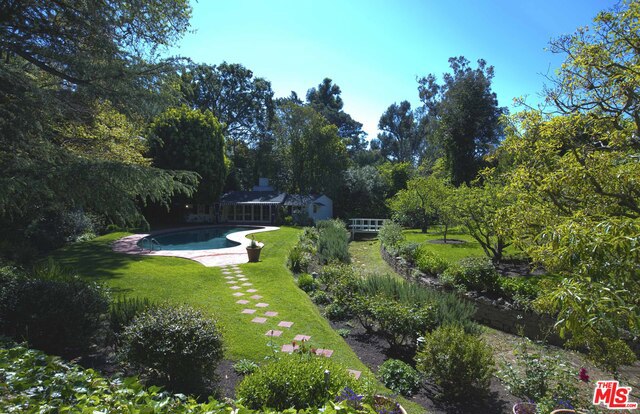 Sitting on just over an acre+ is an extraordinary Country Compound in the style of John Byers set behind gates & up a private drive. French doors and windows throughout look upon courtyards and gardens. Main hse has 3 br + mds/add'l gst rm, formal & junior dining, harvest/fam rm, library, wine cellar, gourmet eat- in kitchen, outdoor dining with wd burning pizza oven. Master suite overlooks this one of a kind property and the forests and meadows it includes. Separate lodge-like gh has 3/4 ba/kitchenette/ fp/ deck and spa. Additional 2 br/2 ba guest house w/ kitchen & fp reminiscent of Gerard Col Cord looks out to pool, stream and orchards. Green house and solarium complete this private sanctuary that is perfect for entertaining and will wow your artists/writers or builder. Old Hollywood one of a kind property that must be seen to be believed. 3 contiguous lots which could be re-imagined to create an outstanding estate in prime Brentwood.