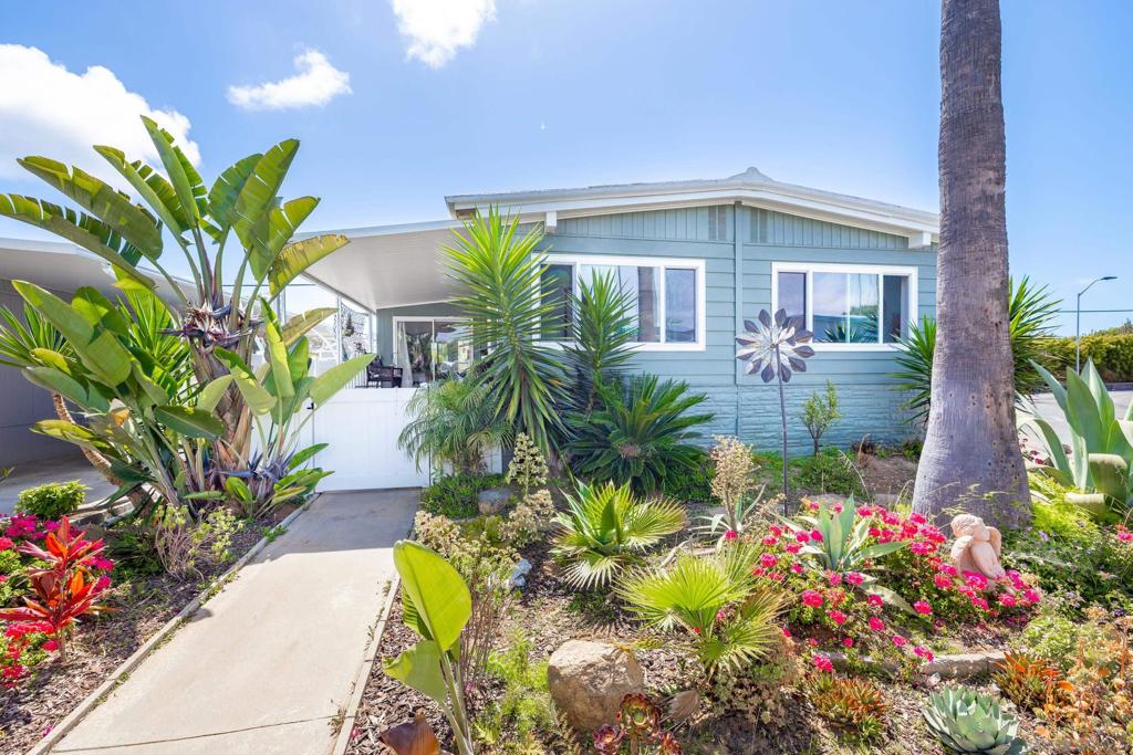 Welcome to your dream home in Carlsbad’s highly desirable Lakeshore Gardens community located just moments from the beach! A beautifully upgraded residence offers the perfect blend of comfort, coastal charm, and active 55+ community living! Upgraded gourmet kitchen with stainless steel appliances and custom cabinetry. Spacious island with bar seating. Separate chef style cooking area with ornate and vibrant tiled back splash! Hardwood laminate flooring, dual pane windows, ceiling fans and recessed lighting. Unique wooden double door entry to living room with a projector and projection screen for a full theater style experience! Spacious primary suite with walk-in closet and spa-inspired bathroom with separate shower and soaking tub! Upgraded second bath. Enclosed patio/bonus room. Full home water filtration system. Expansive attached shed containing two separate areas within providing plenty of room for storage. Vinyl fencing at front and side of home. Located on a corner lot in rear of community with only one adjacent neighbor. Prepare to be impressed from the moment you step inside! You'll appreciate the attention to detail and unique design of home! If you're ready for the best of coastal life, this home is it! The community offers lush landscaping, greenbelts, mature trees and various lakes throughout giving your environment a "park-like" feel. It also offers a pool, spa and workout room. The upper level of the clubhouse contains offices, lobby, card room with fireplace, billiard room and a beautiful balcony to enjoy lake views. The lower level offers a well stocked library, recreation room with a stage, commercial grade kitchen, ceramics room and restrooms. Outside there is an extensive patio with a fountain, fire pit, and fireplace. An excellent area to sit and enjoy gatherings with friends and neighbors. A shopping plaza with grocery store, nail salon and more is located directly across the street from the main gate.