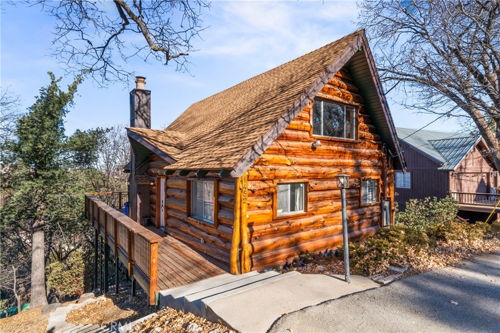 Beautifully updated 4-bedroom, 3-bath log-sided home with coveted full lake rights, perfectly situated in the serene mountain community of Lake Arrowhead. This spacious almost level-entry home offers approximately 1,600 sq/ft of thoughtfully designed living space, ideal for both full-time living and vacation getaways. Step inside and be welcomed by a bright, open floor plan designed for entertaining. The main level features soaring vaulted ceilings, a grand stone fireplace, and wood-trimmed custom windows that showcase this space in natural light while framing tranquil forest views. The fully renovated kitchen seamlessly flows into the dining and living areas, creating the perfect space for gatherings, celebrations, or cozy nights. Two generously sized bedrooms and a beautifully remodeled full bathroom, highlighted by chunky wood trim throughout, complete the main level. Upstairs, a private loft-style en-suite bedroom offers a peaceful retreat with its own full bath, perfect for guests or a quiet office. The lower level features a large, separate en-suite bedroom with remodeled bath, spacious living area, and ample storage. Outdoor living is equally impressive with an expansive wrap-around deck that offers abundant space for entertaining, dining al fresco, or simply relaxing while enjoying stunning mountain sunsets and crisp mountain air. Located just minutes from Lake Arrowhead Village, the marina, schools, and local amenities, this home strikes the perfect balance between peaceful mountain living and convenient access. Fully renovated and possibly turnkey, this home blends rustic mountain charm with modern upgrades and luxurious finishes. With level entry access and exclusive lake rights, this property is truly an entertainer’s dream in one of Southern California’s most desirable mountain communities. Schedule your tour today and discover the perfect blend of comfort, style, and nature in this updated Lake Arrowhead Gem!
