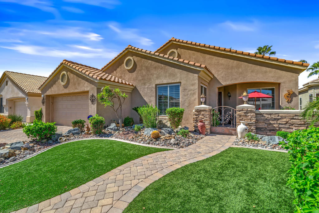 SPECTACULAR VIEWS from this 2407 sq.ft. 2 bed, 2 bath PLUS DEN home in Heritage Palms C.C. Featuring beautiful brick paver driveway AND extended paver front and rear patios, artificial turf, desert style landscaping, entry courtyard and leaded glass front door. This spacious OPEN DESIGN has plenty of room for your large dining parties, casual bar with sitting area to entertain guests and family room off of the beautiful island design kitchen with new stainless appliances. Additional upgrades include recently replaced dual A/C units, garage A/C, plantation shutters, French patio doors and electric sun shades across the entire extended rear patio that has dramatic views of the 14th and 15th fairways, lake w/fountain and panoramic VIEWS of the mountains. The large primary suite has dual vanities, separate tub & shower and a large walk-in closet. This unique layout also includes an oversized laundry room with loads of cabinetry and folding counter. Heritage Palms is a premier adult community featuring an 18 hole championship golf course, indoor & outdoor pools, pickle ball & tennis courts, fitness center, grill room, card rooms, social clubs and more.